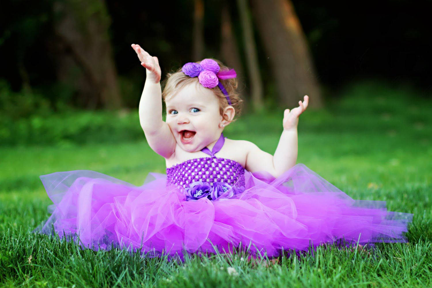 Relaxed Baby in a Soft Purple Gown Wallpaper