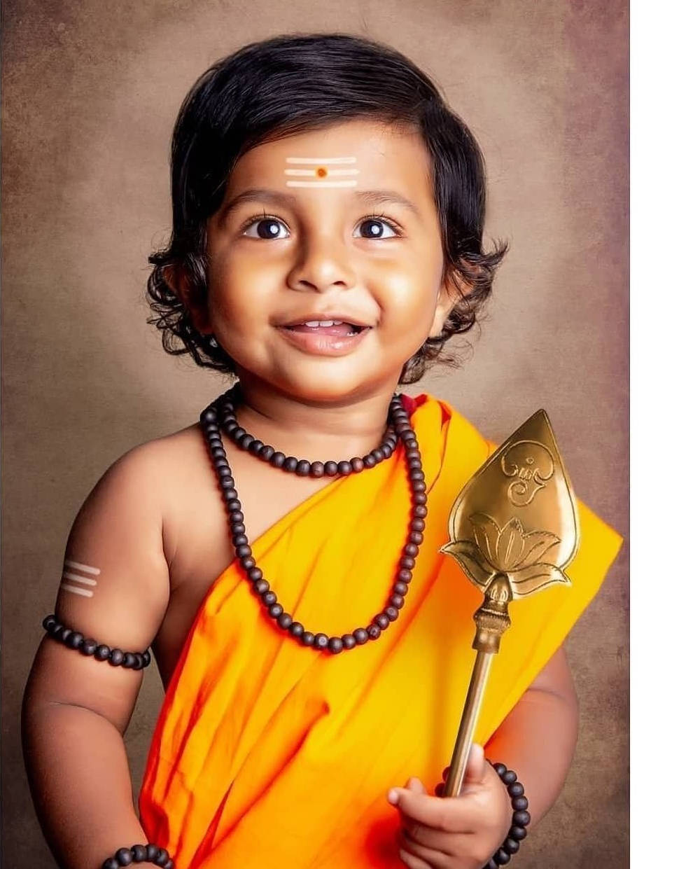 Download Baby Murugan With Gold Veera Vel Wallpaper | Wallpapers.com