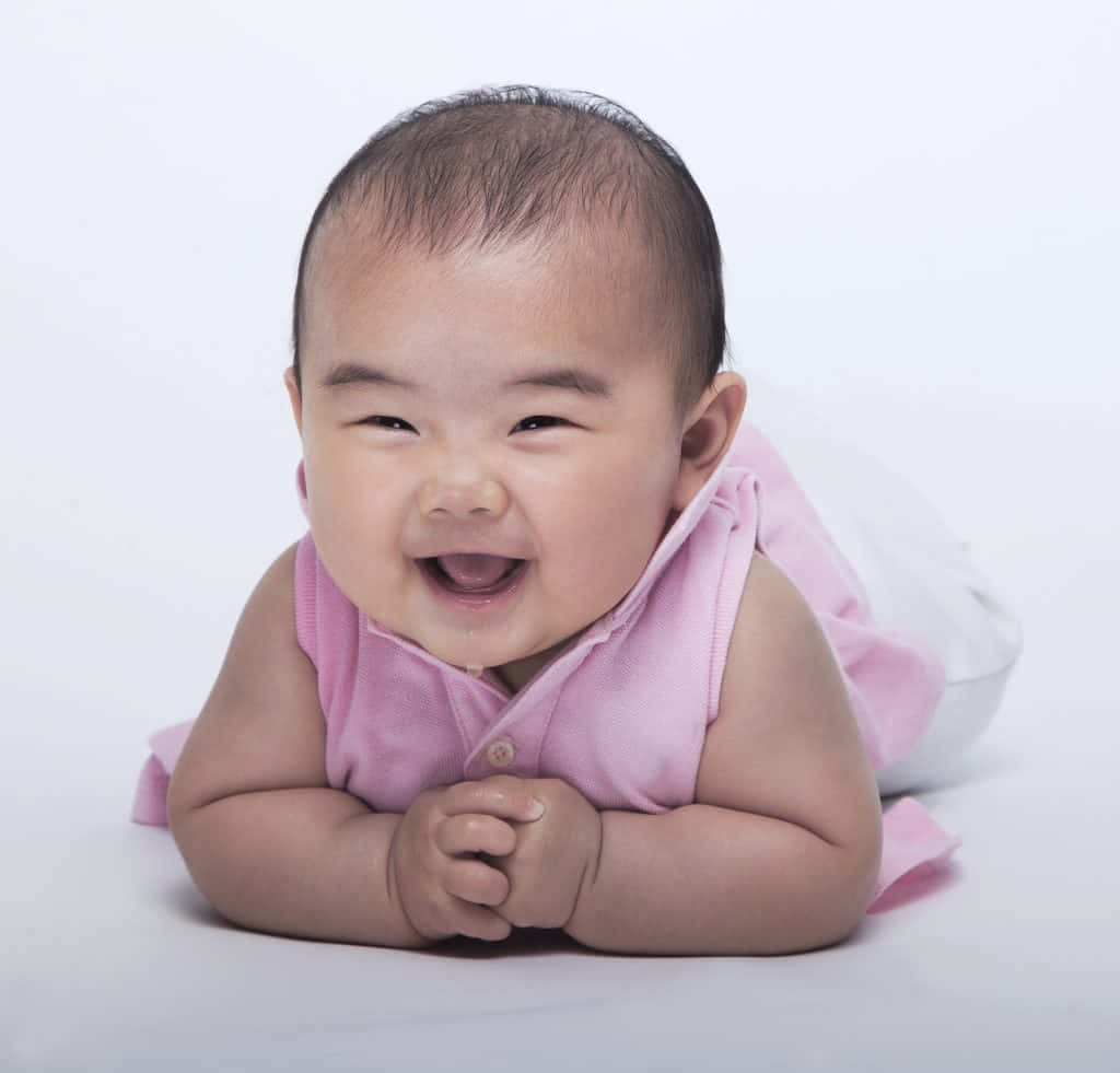 Bildmed Leende Asiatisk Baby