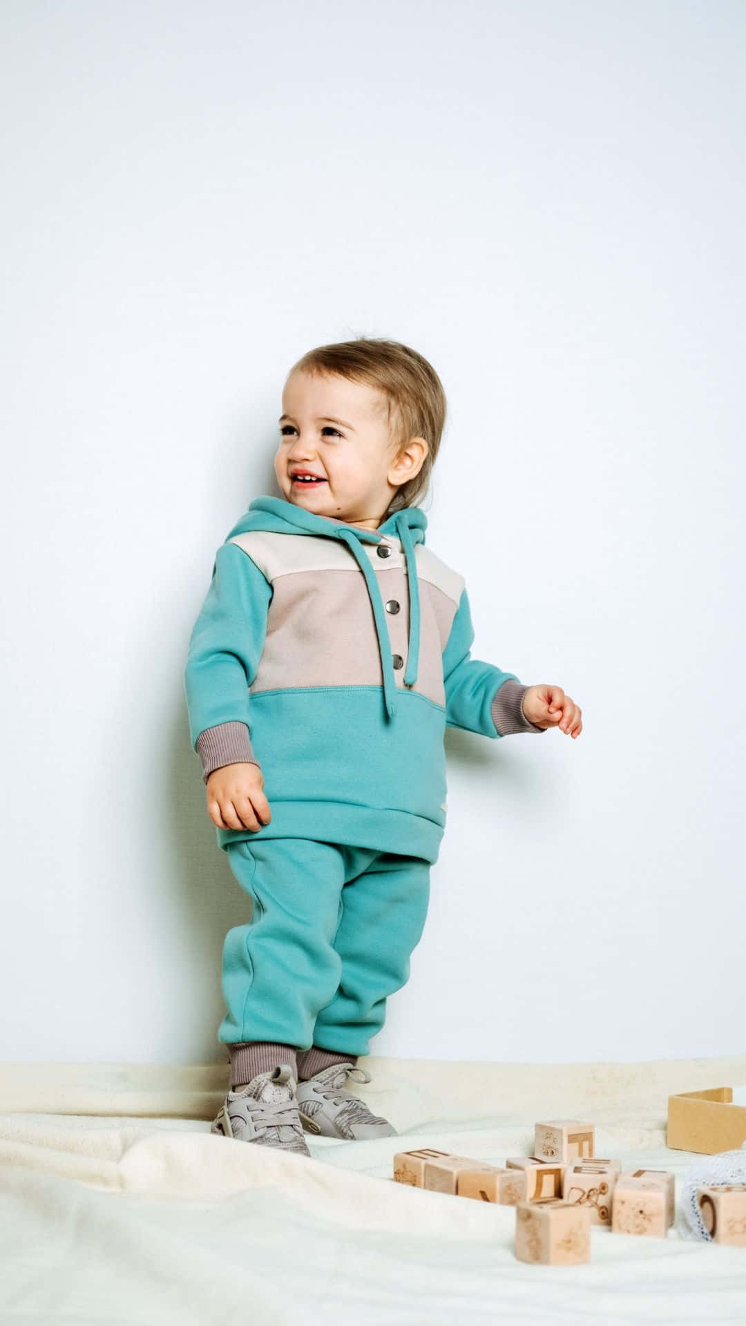 Baby Stylish Boy Wearing Blue Hoodie Wallpaper