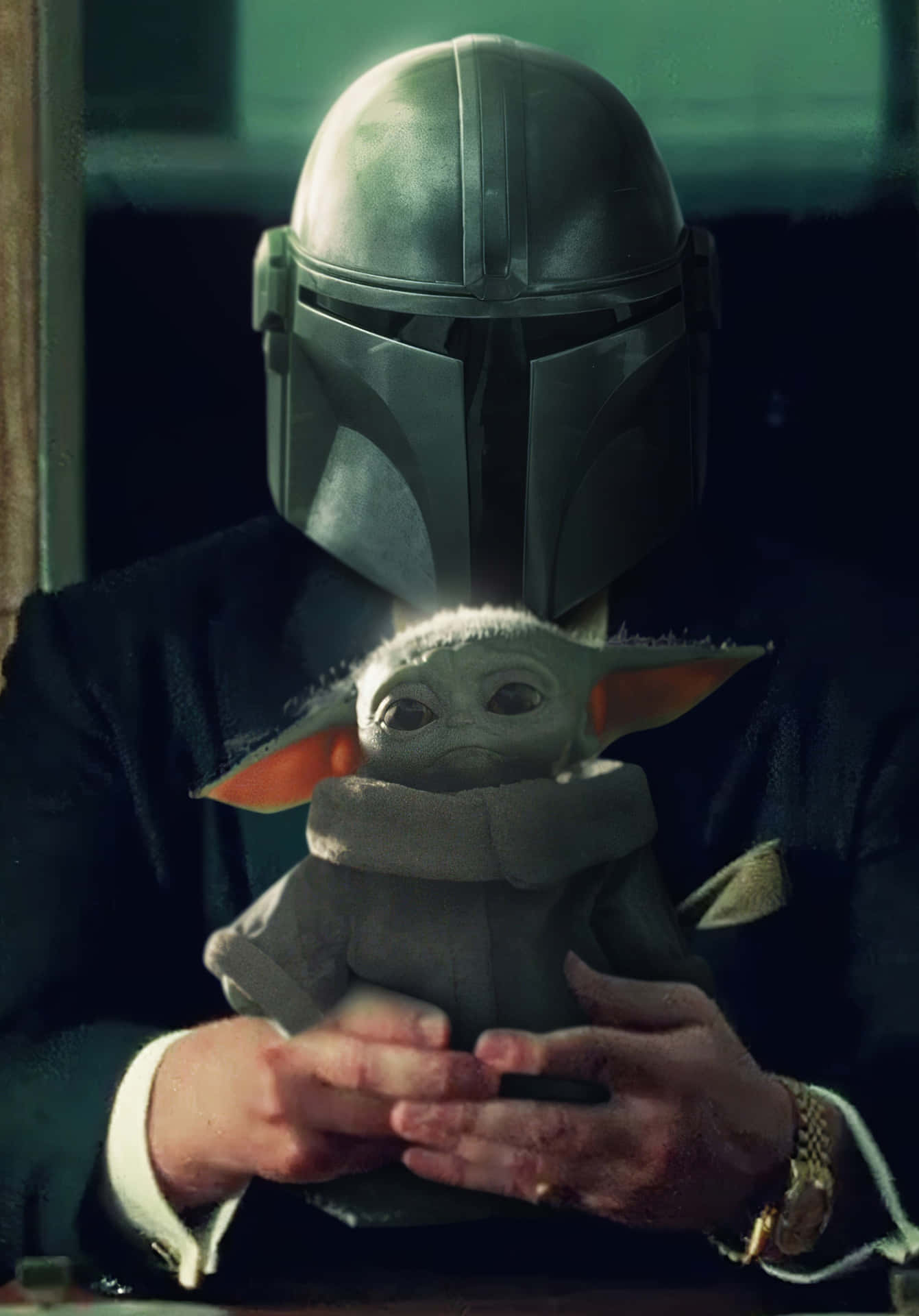 The Mandalorian Is Holding A Baby Doll Wallpaper