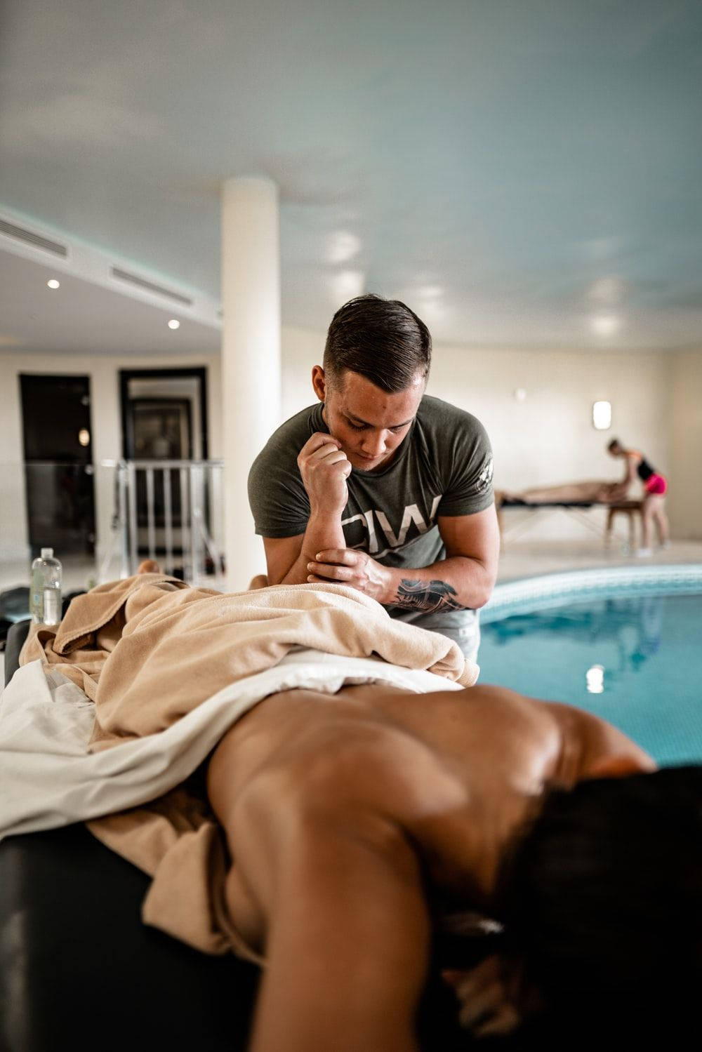 Therapeutic Poolside Back Massage Wallpaper