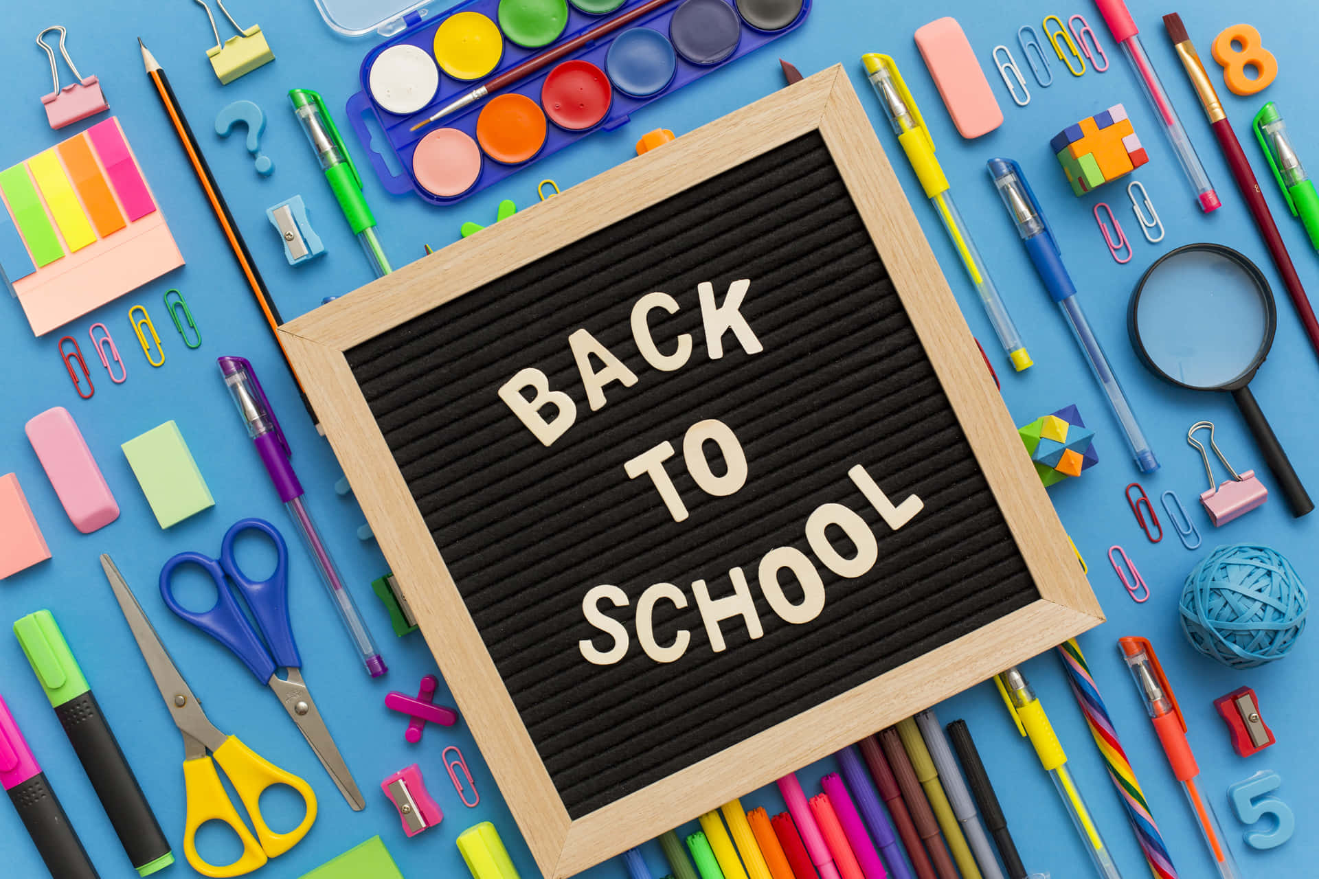 Back To School Supplies On A Blue Background Wallpaper