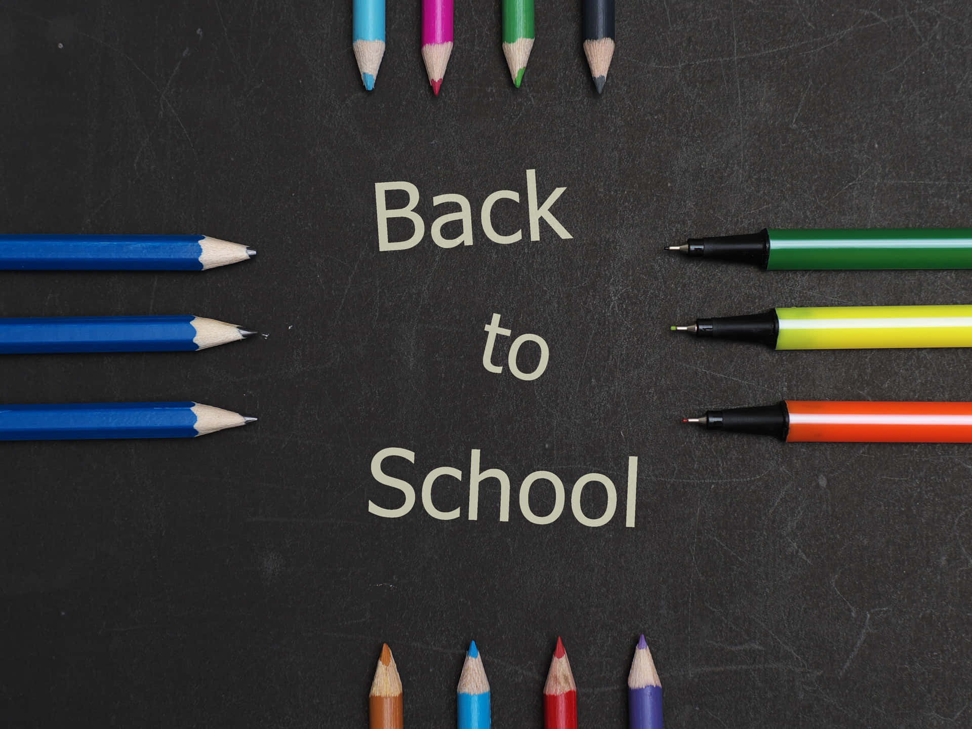 A Group Of Colored Pencils With The Word Back To School Wallpaper