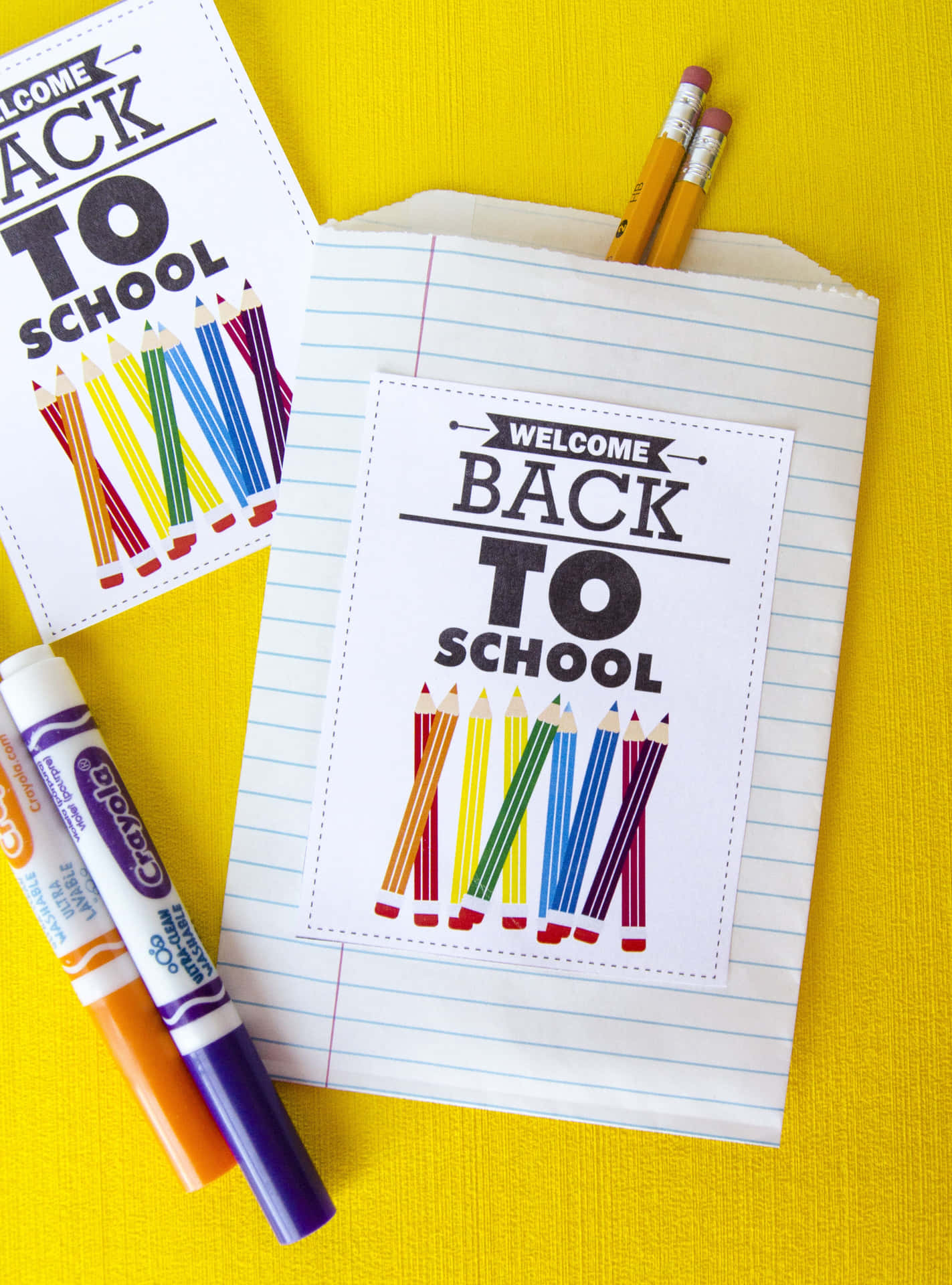 A Back To School Bag With Crayons And Markers Wallpaper