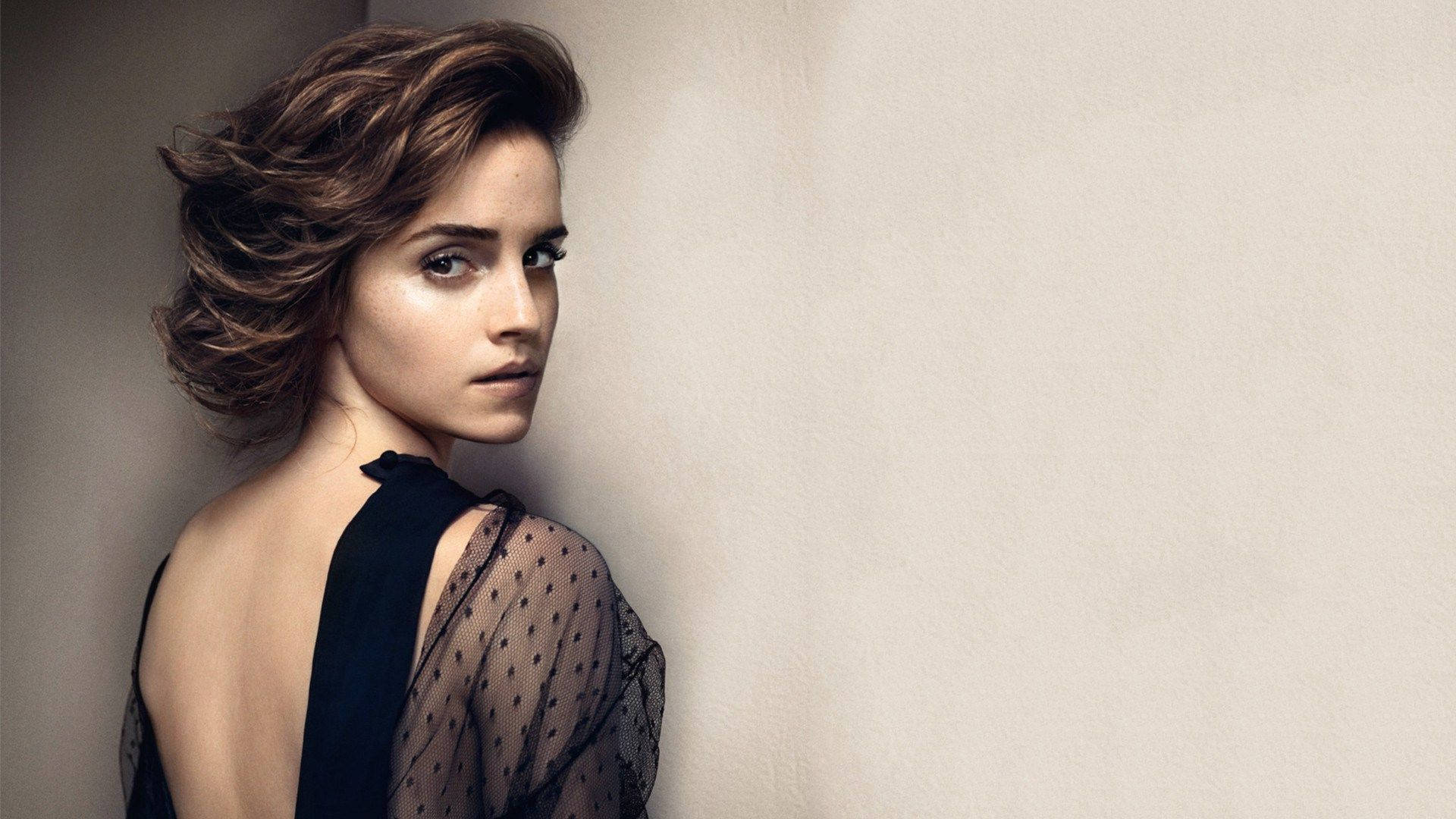 Emma Watson looking elegant in backless art Wallpaper