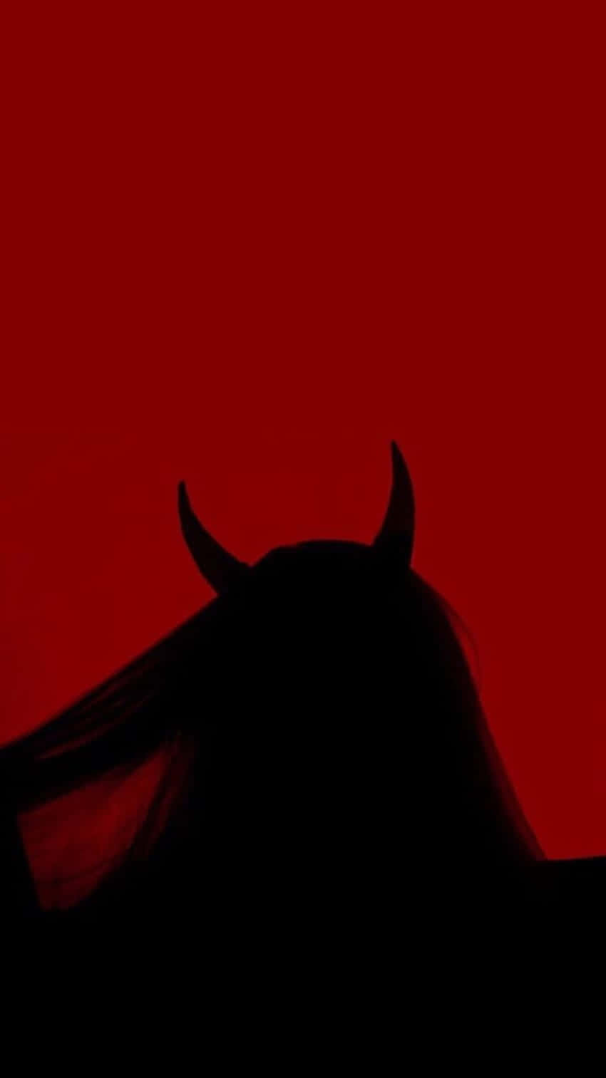 A Silhouette Of A Woman With Horns In Front Of A Red Background Wallpaper
