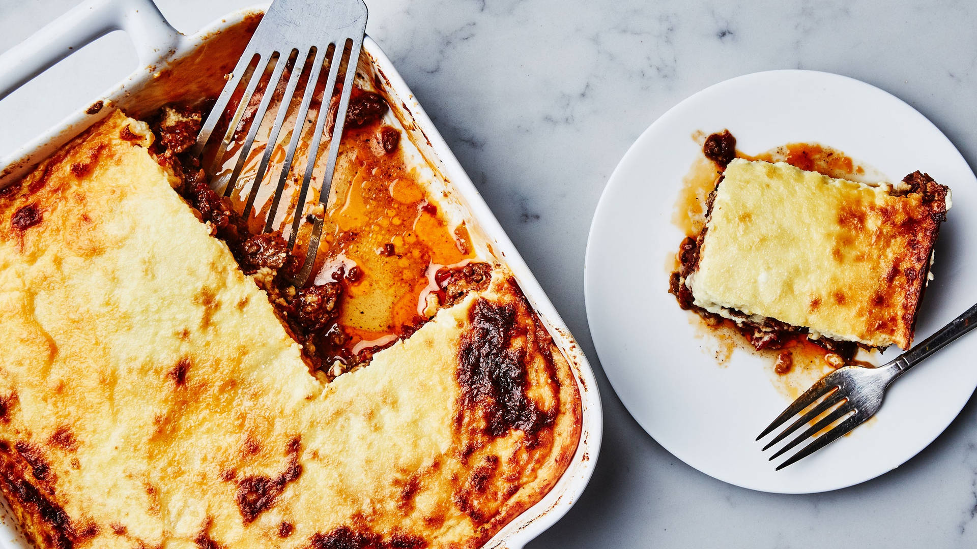 Baked Moussaka On A Serving Tray And White Ceramic Wallpaper