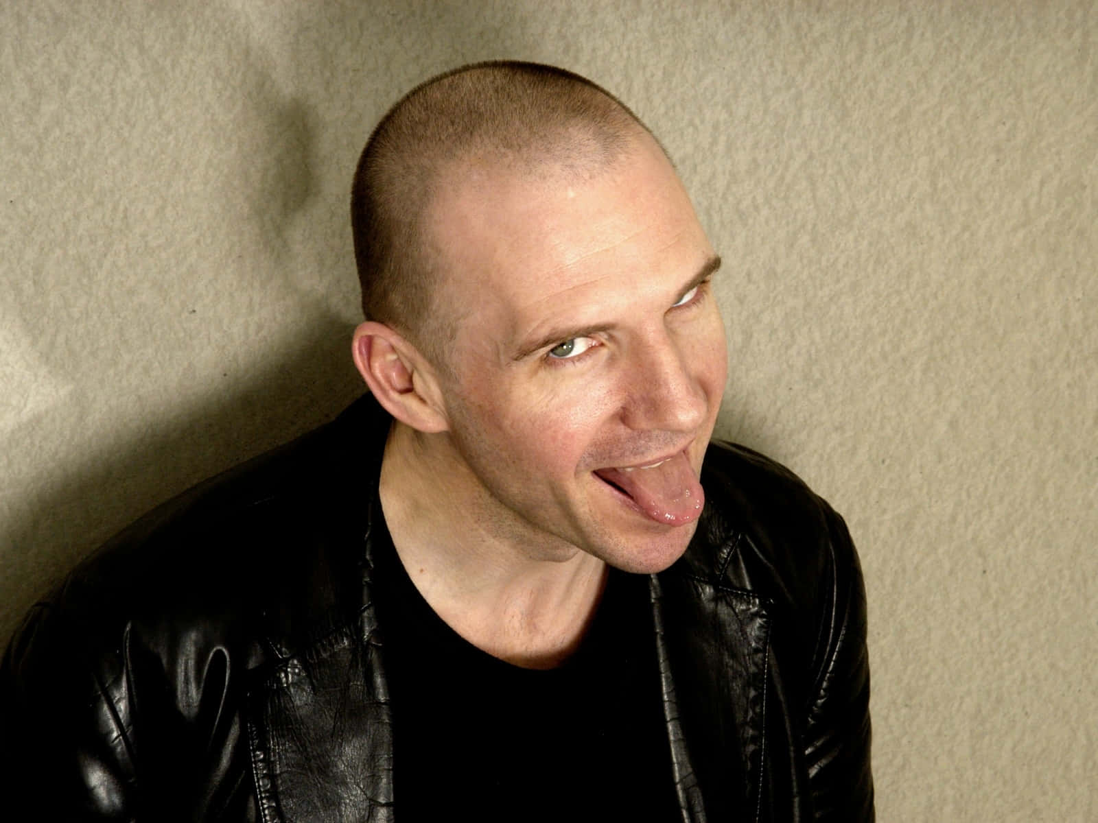 Bald Man Sticking Out Tongue Wallpaper