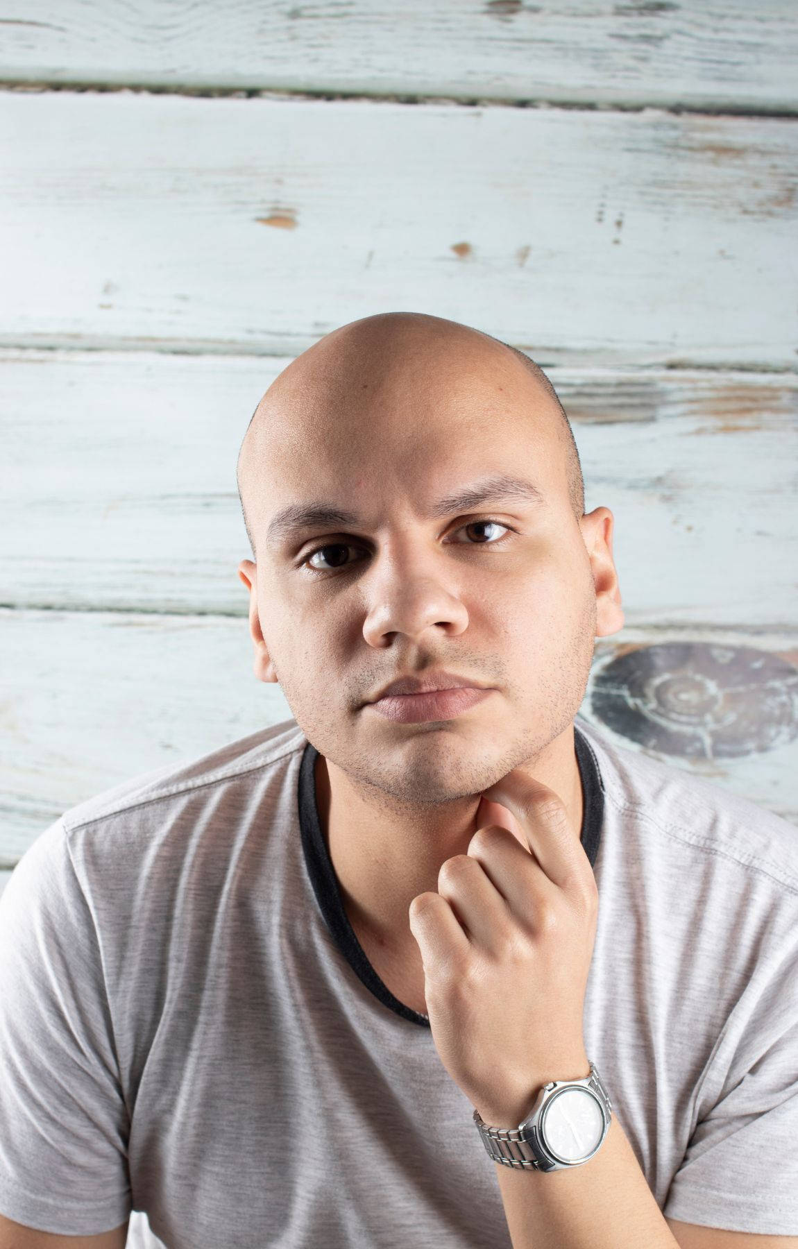 Bald Man Wearing A Gray Shirt Wallpaper