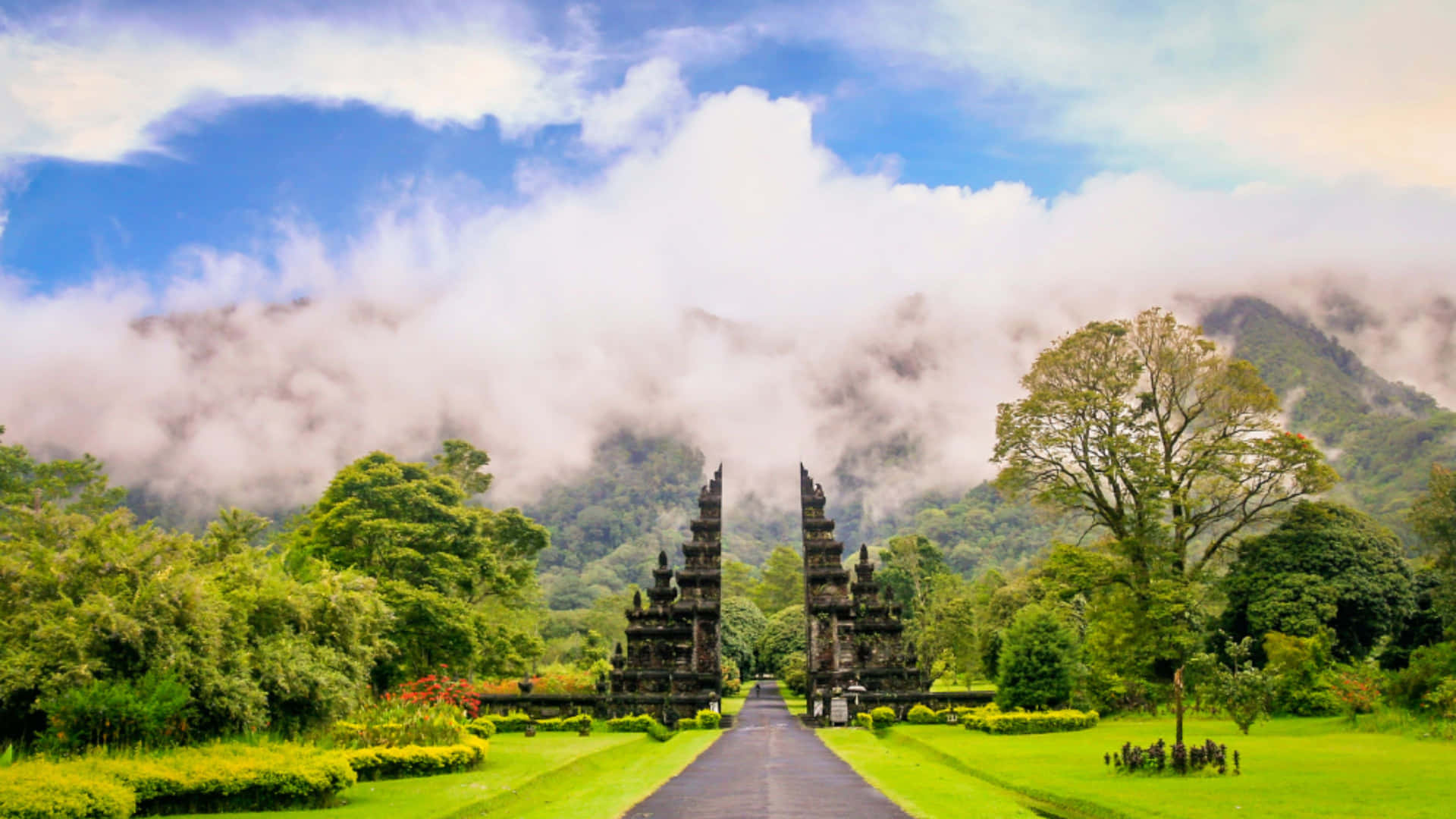 Majestic Balinese temple overlooking a serene lake and lush greenery