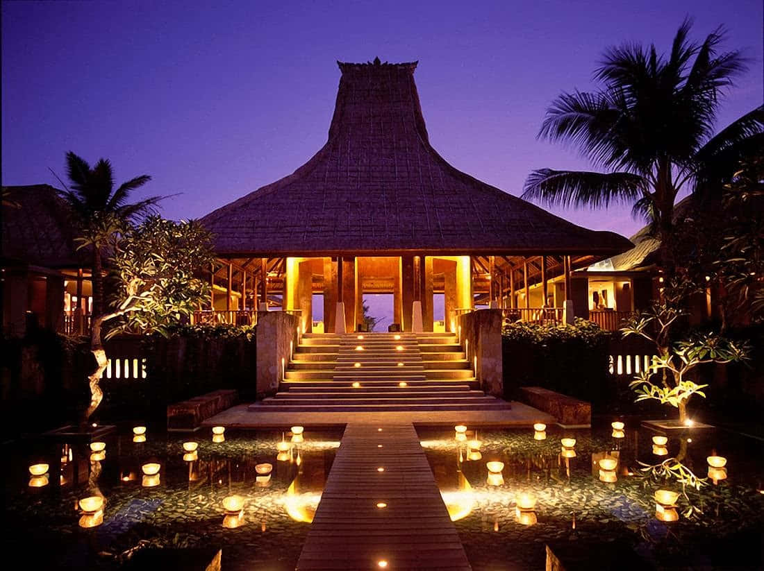 A Resort With A Lit Walkway And Candles