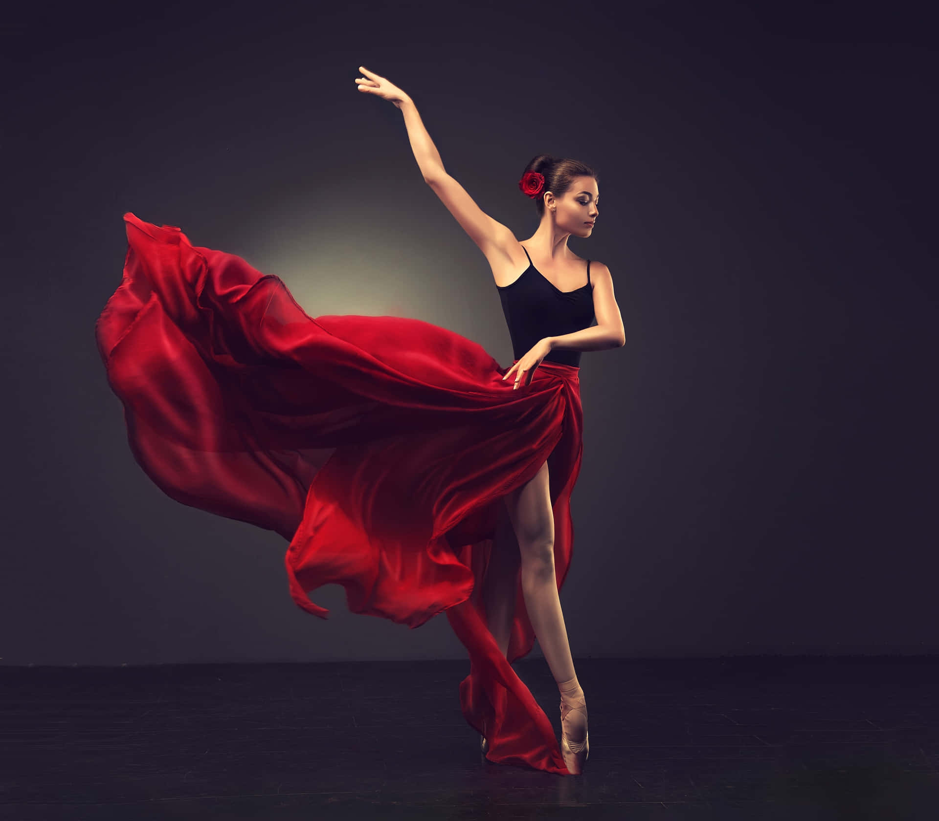 A Woman In A Red Dress Is Dancing