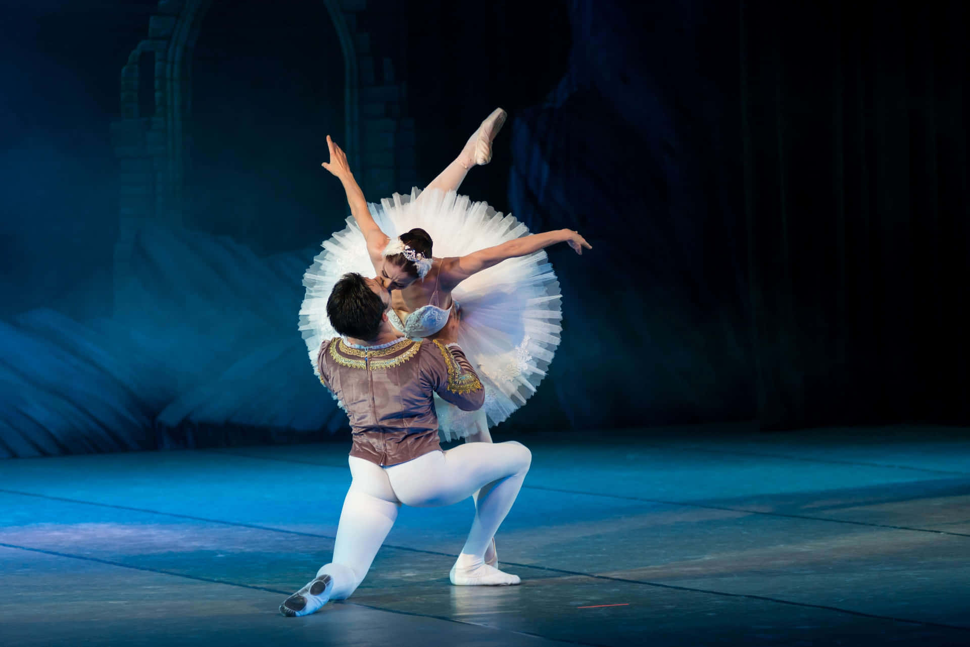A Couple Of Ballet Dancers Performing On Stage