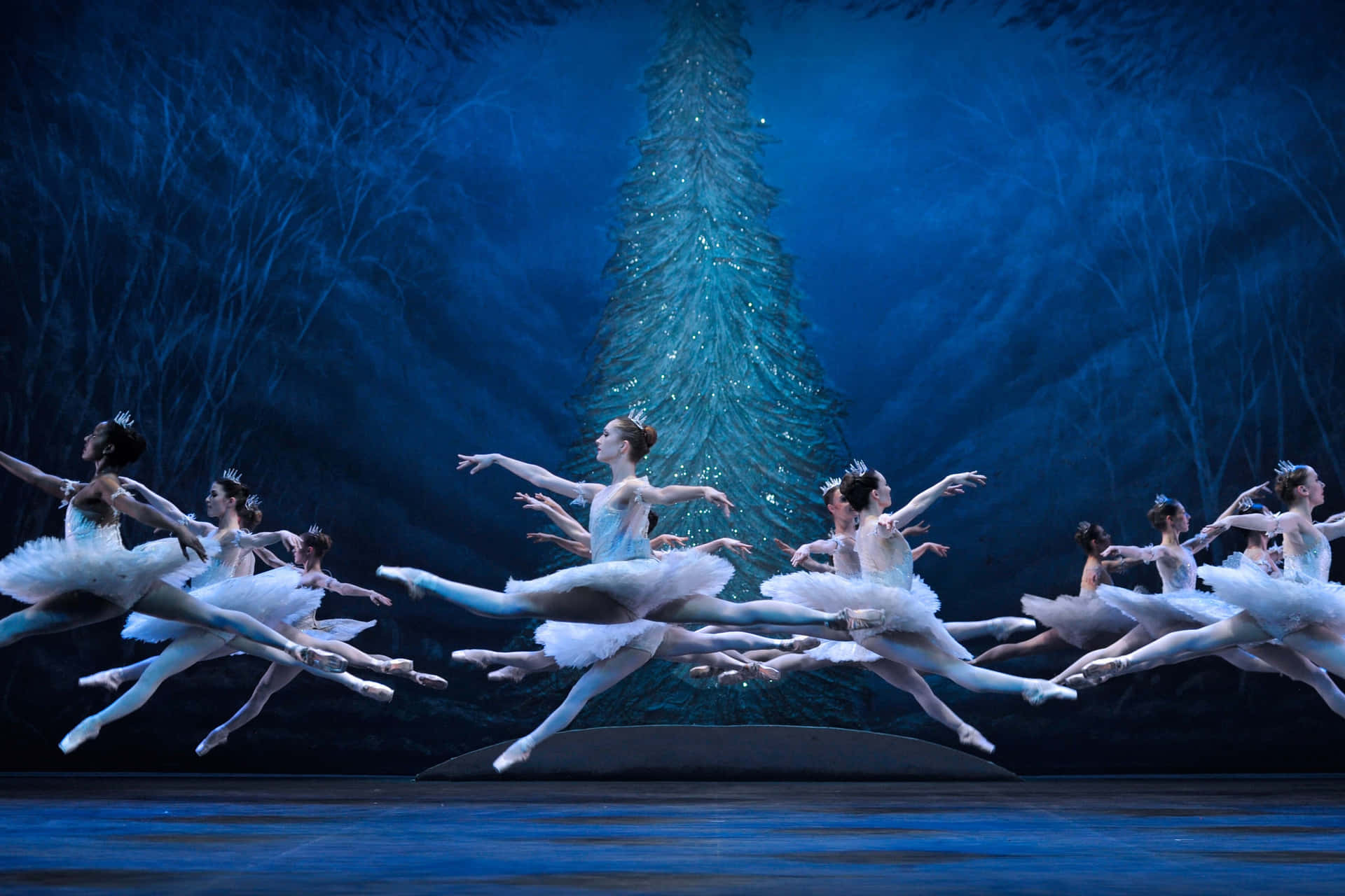 The Ballet Dancers Are Performing In Front Of A Tree