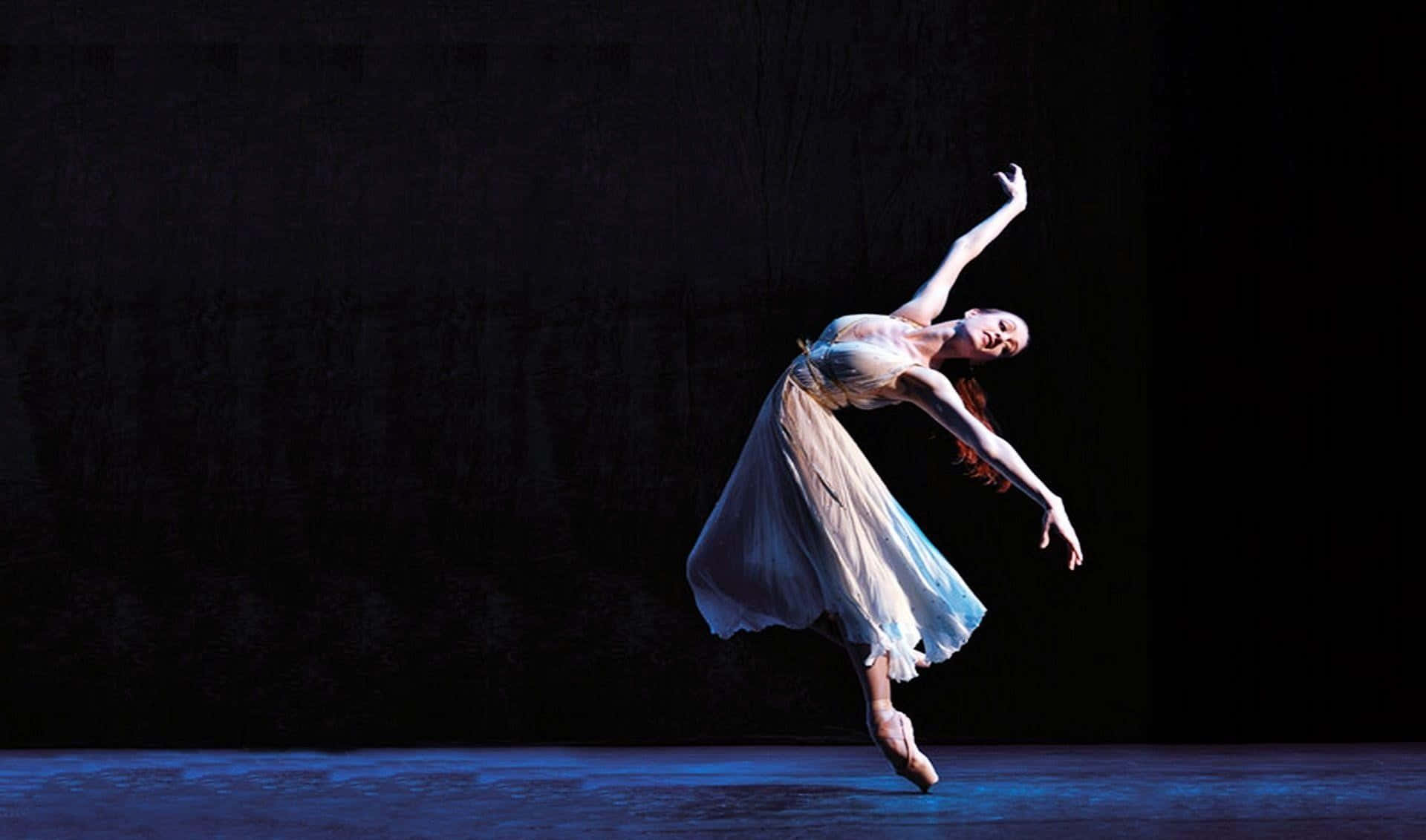 A Female Ballet Dancer In A White Dress