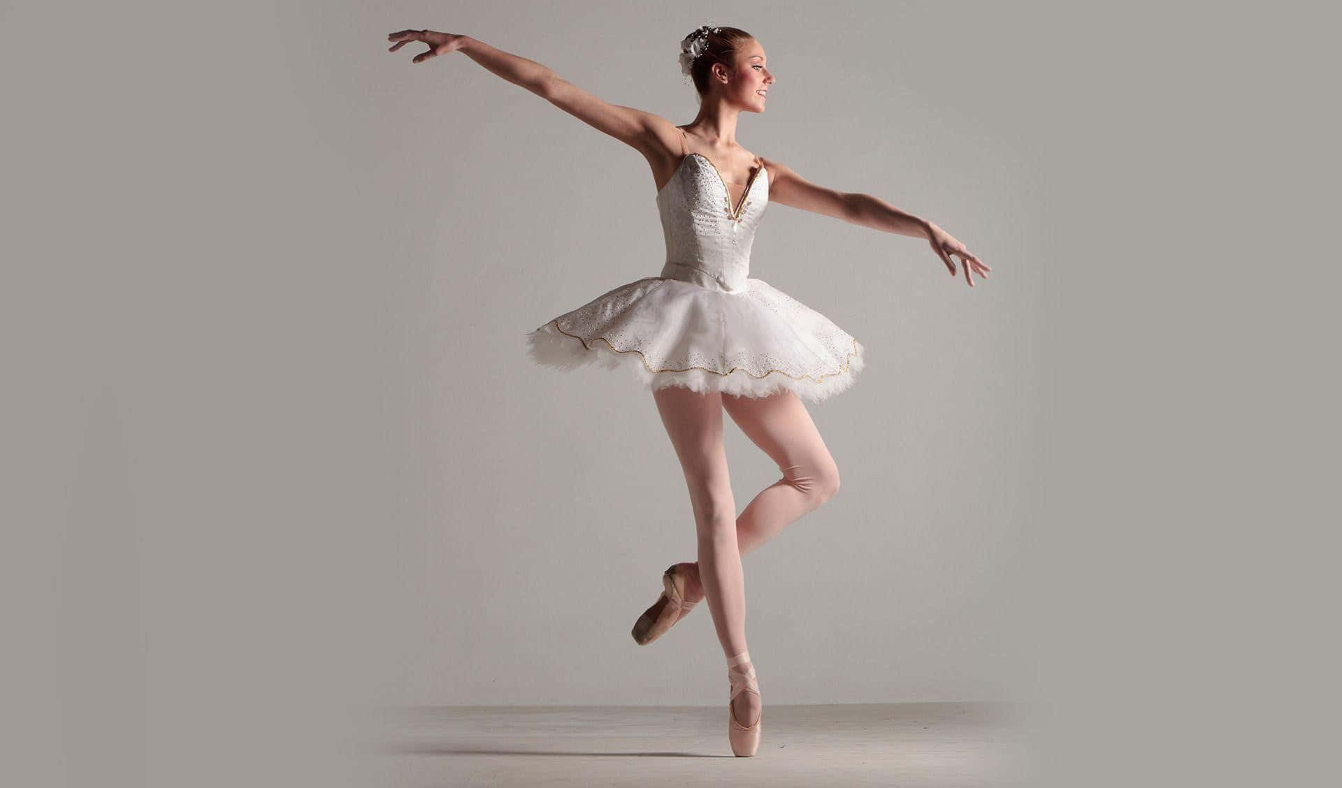 A Young Woman In White Ballet Dress Is Posing