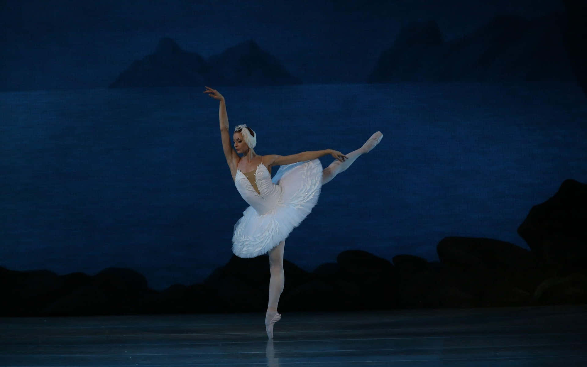 A poised ballerina practices her pirouette in a studio.