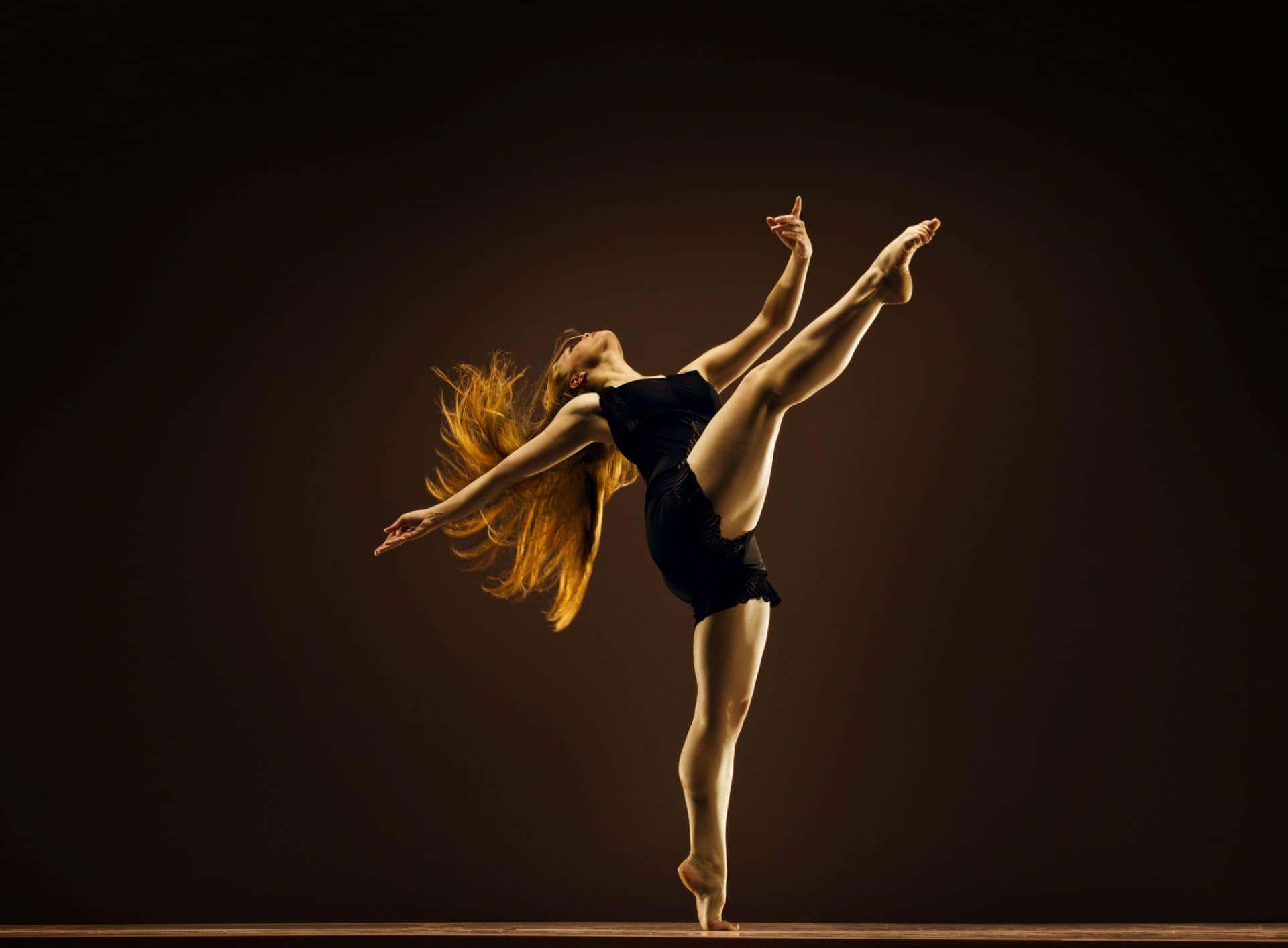 A graceful ballerina in full costume glides atop a ballet studio dance floor