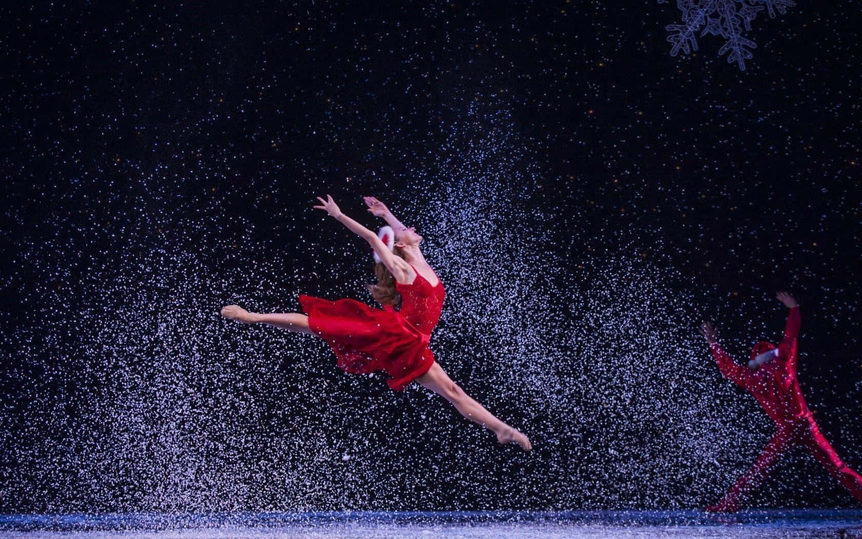 A Dancer In Red Jumps Into Snow
