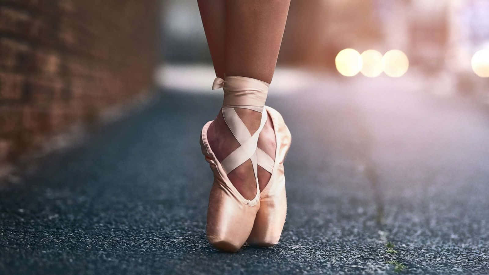 A Woman Wearing Ballet Shoes Walking Down The Street Wallpaper