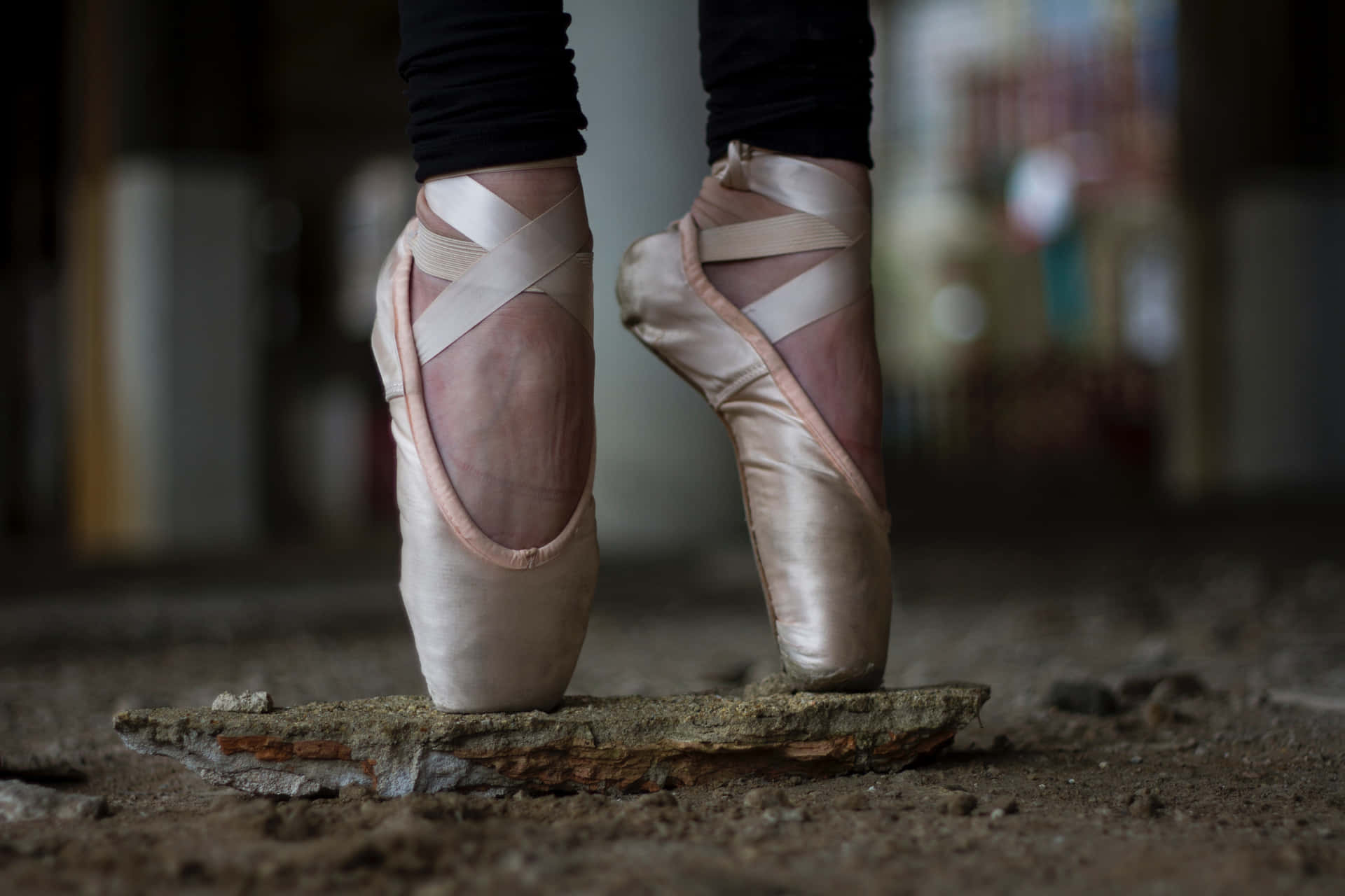 A Woman's Feet In Ballet Shoes Standing On A Rock Wallpaper