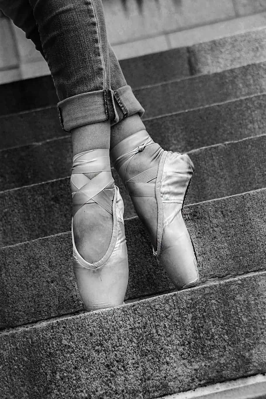 A Woman Wearing Ballet Shoes On The Steps Wallpaper