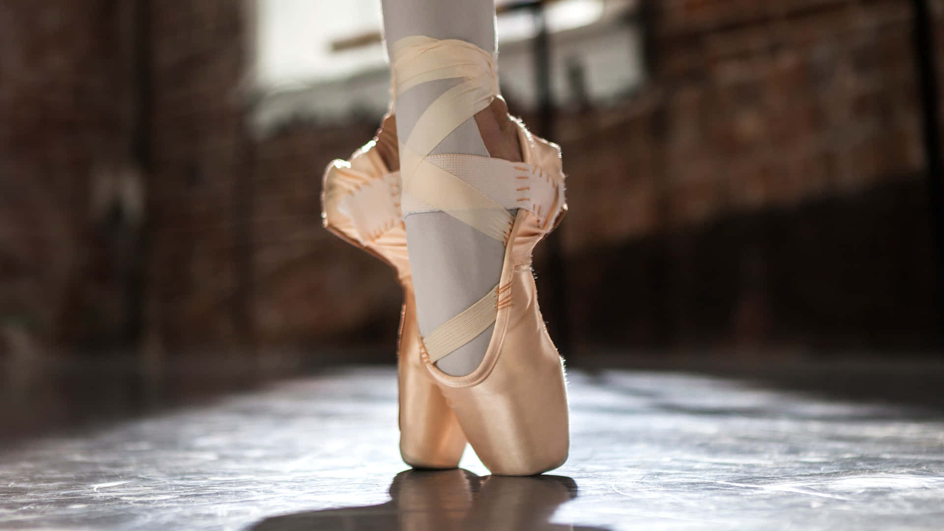 A Ballet Dancer's Feet Are Standing On A Floor Wallpaper