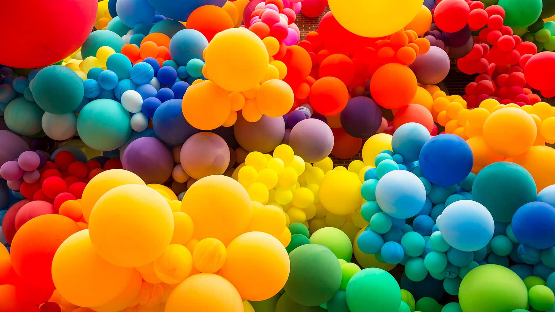 Colorful balloons freed from their strings and floating up towards the beautiful blue sky
