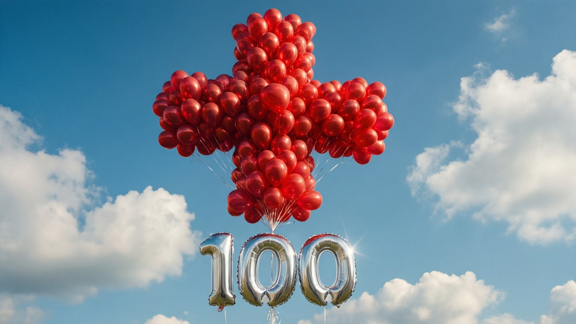 Rødt kors laget av ballonger med 100-tekst