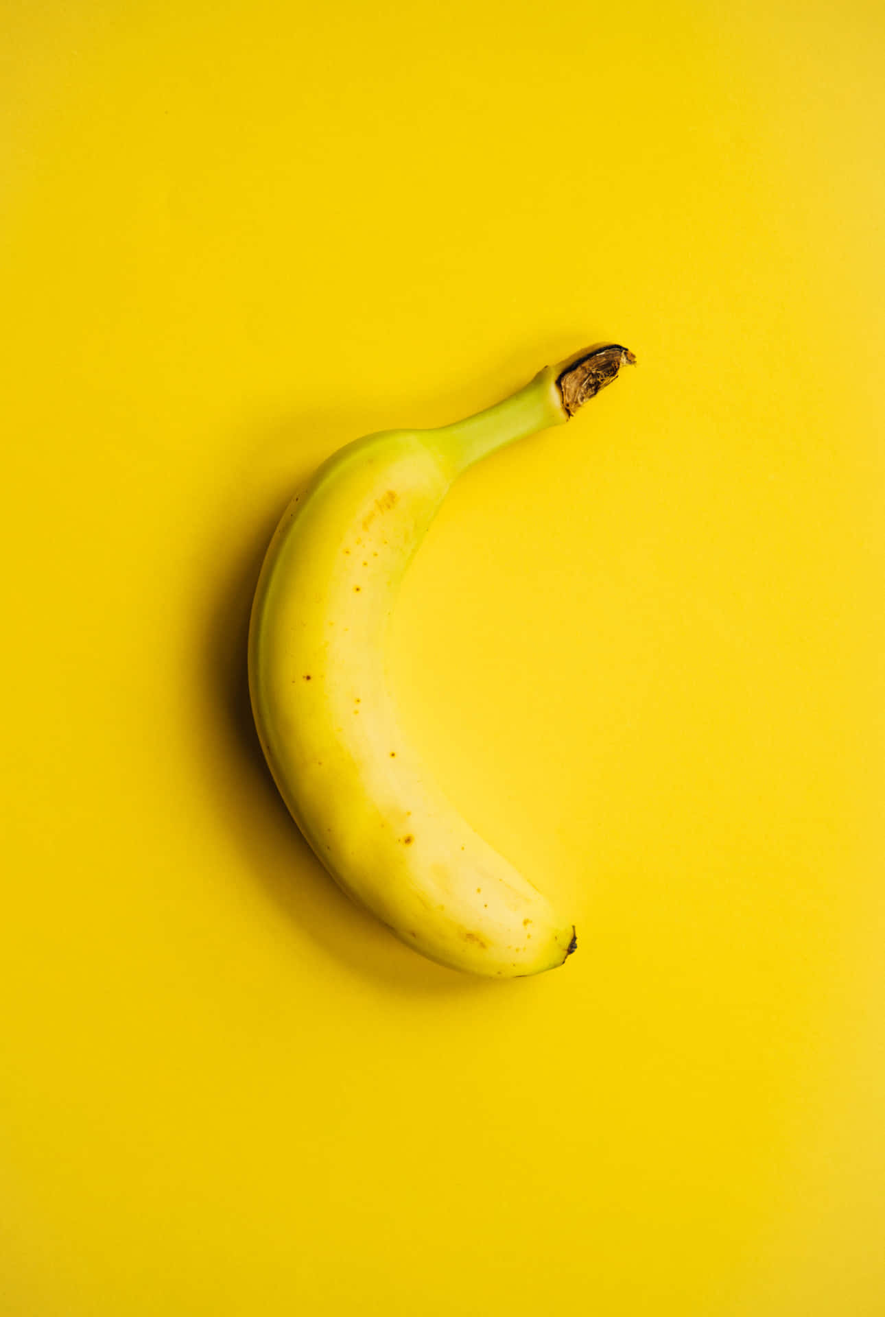 A Banana On A Yellow Background