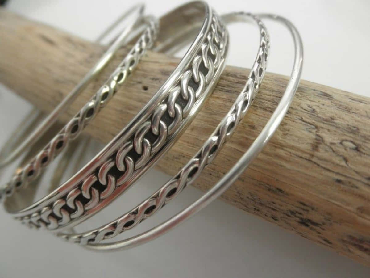 A Set Of Silver Bangles With Braided Designs