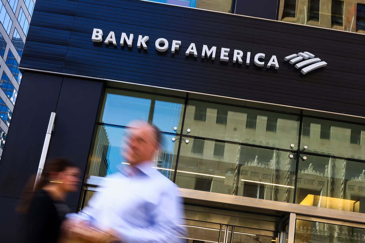 Bank Of America - A Man Walks Past A Bank Of America Building