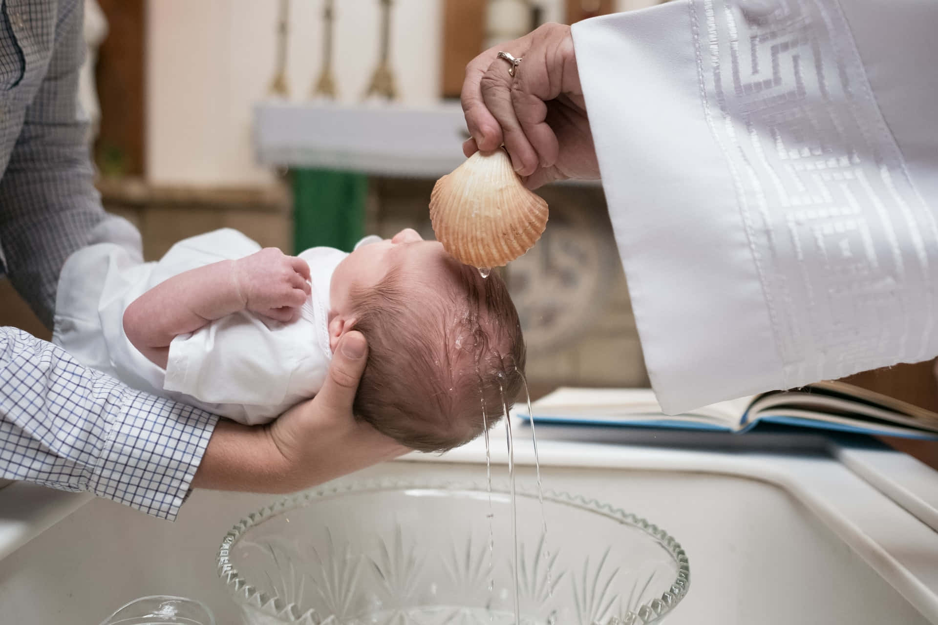 A Baby Being Baptized In A Church
