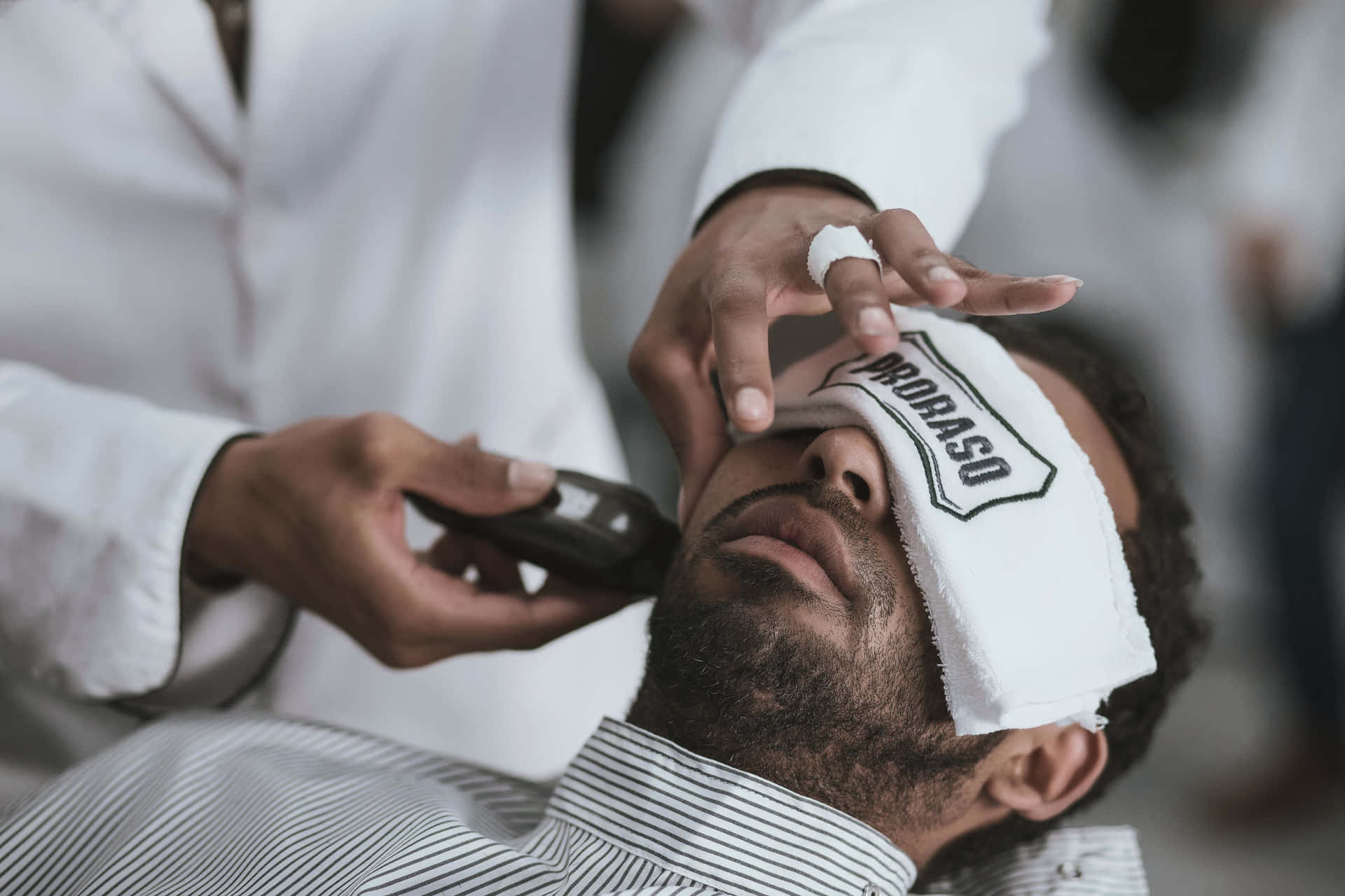 Professional barbers at work crafting custom styles