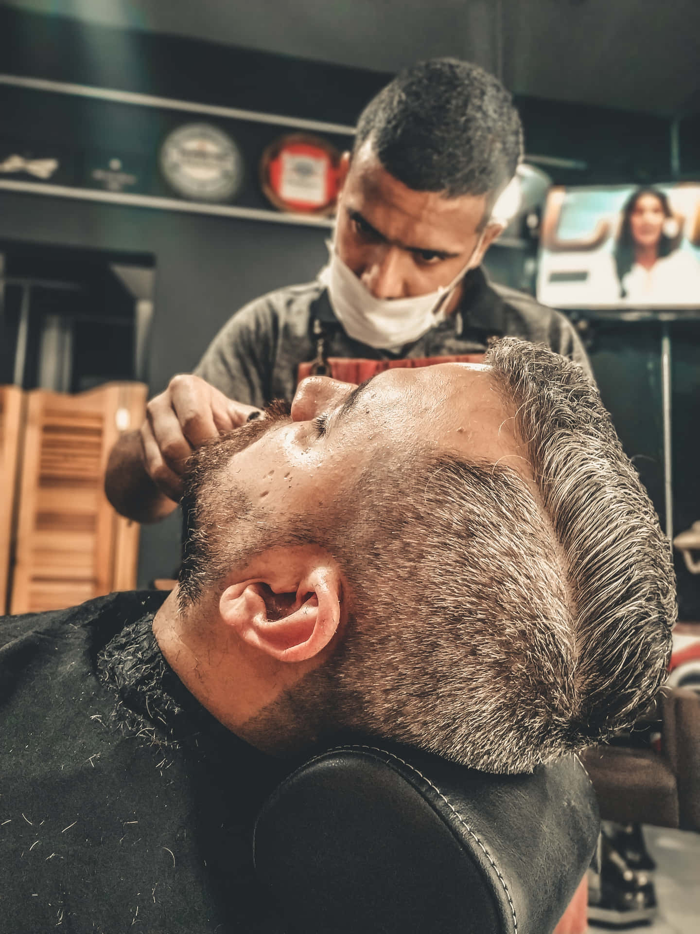 Barber Cutting The Hair Of The Customer With Face Mask Wallpaper