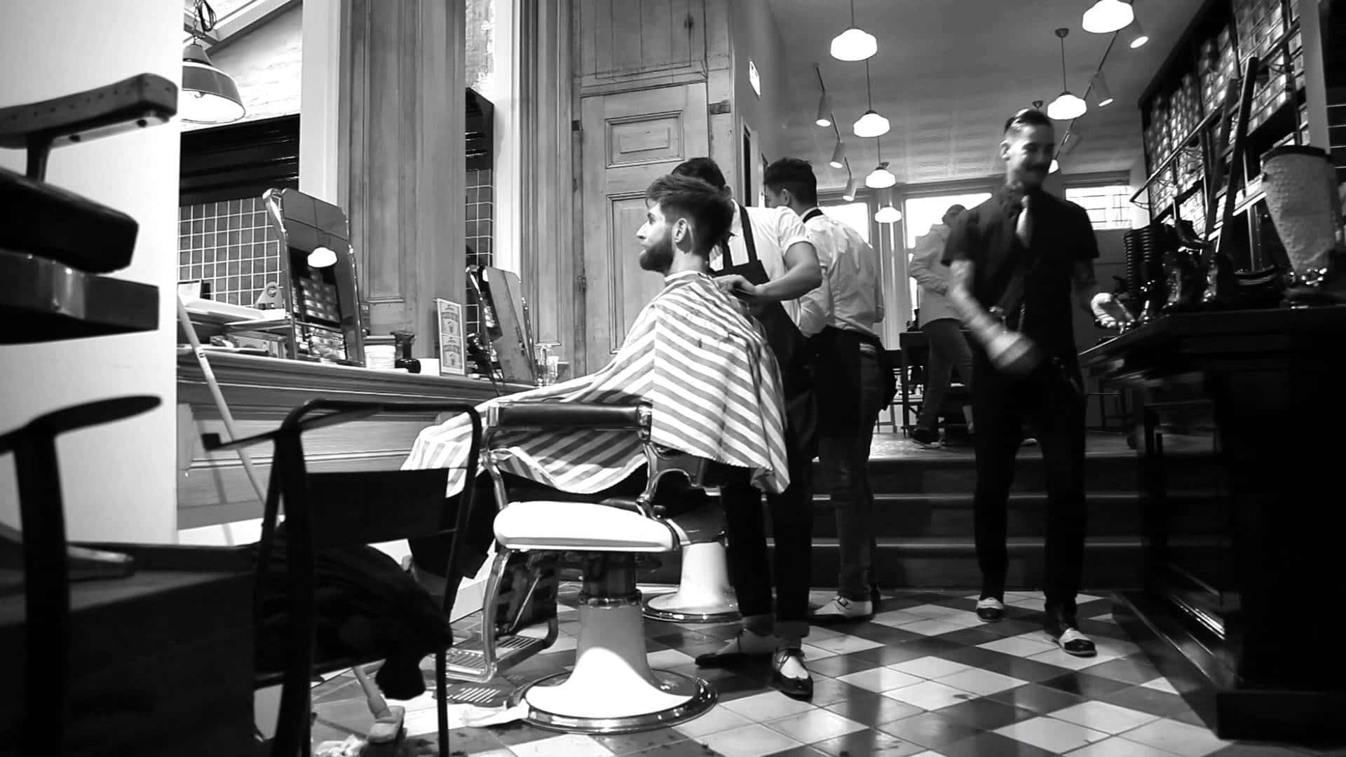 A Barber Shop With A Man Sitting In A Chair