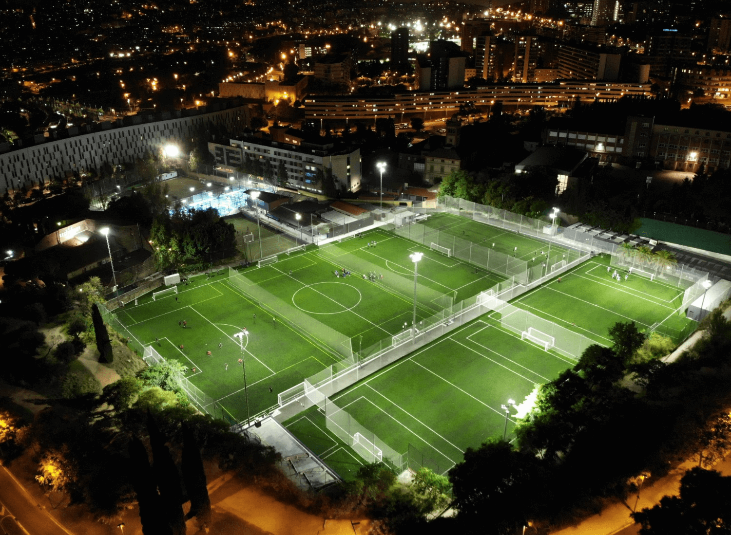 A Soccer Field At Night With Lights On It