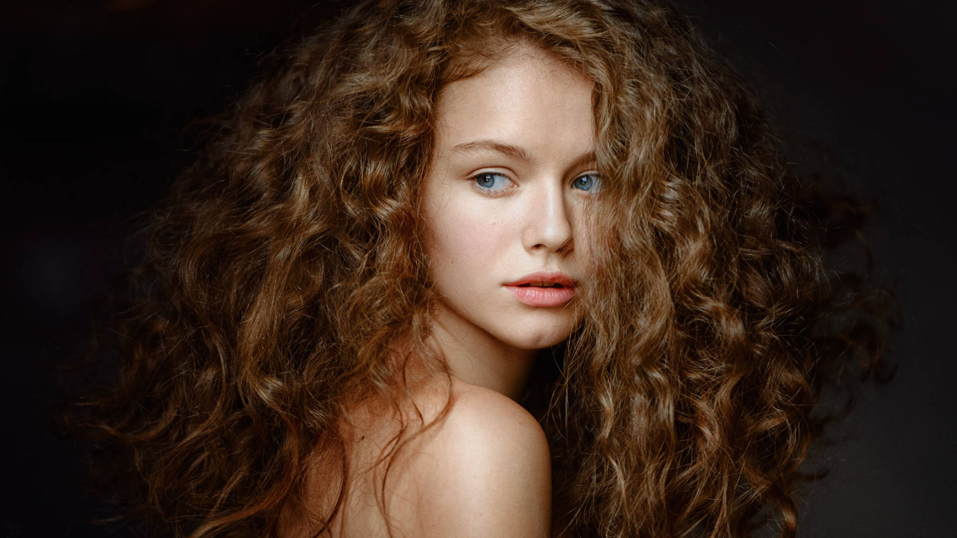 Bare-faced Woman With Curly Hair Wallpaper