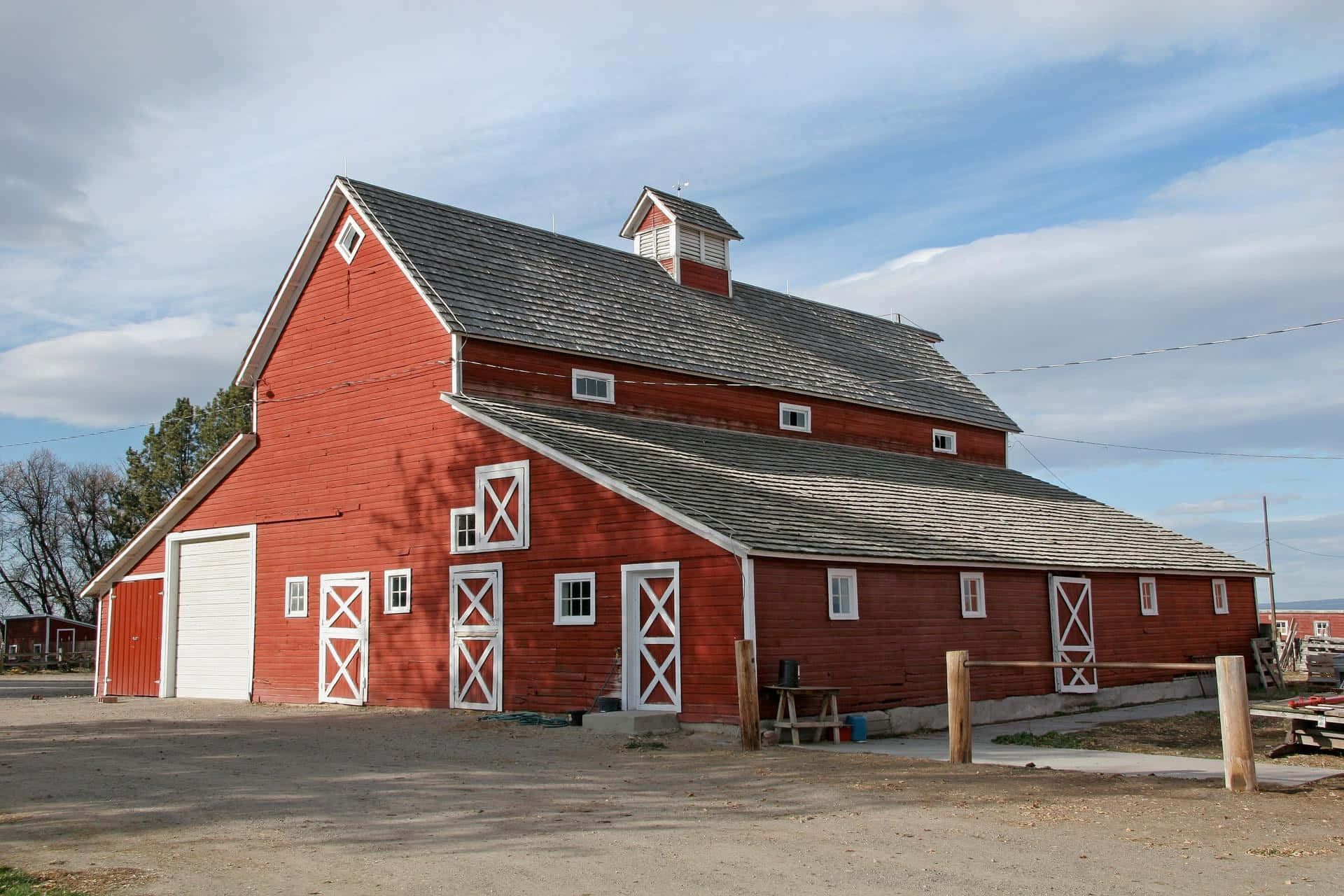 A Red Barn With A White Roof And A Garage