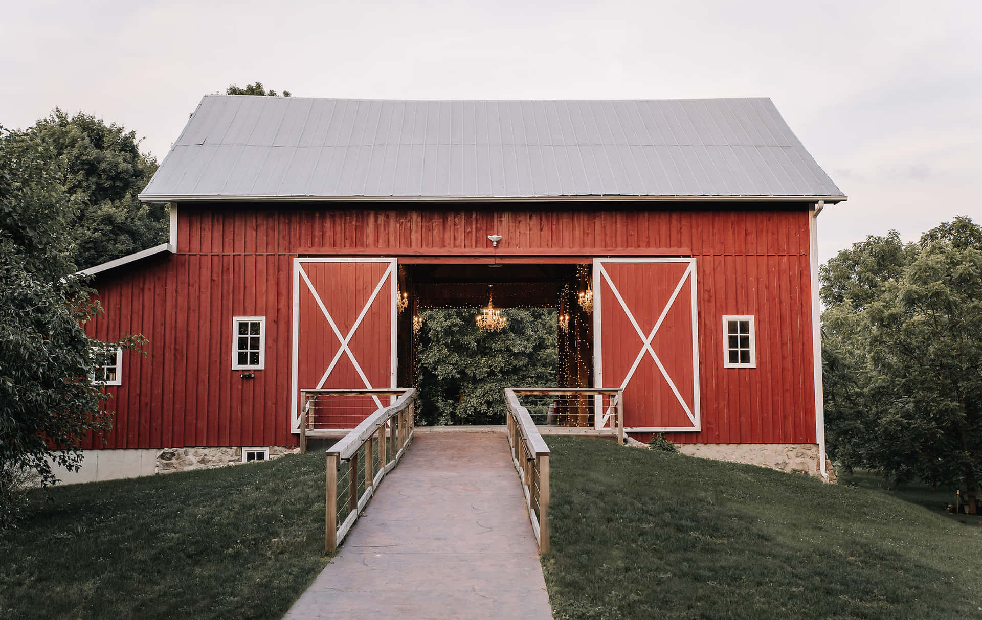 An old wooden barn surrounded by lush greenery