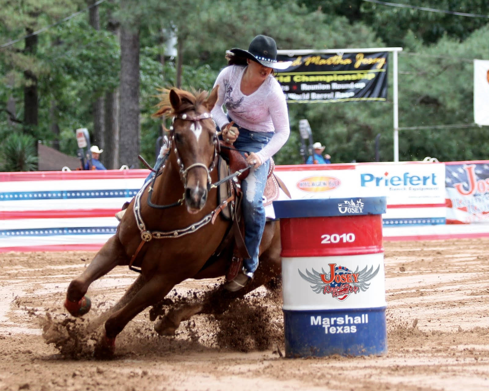 Horse Performing A Tight Turn During A Barrel Racing Event Wallpaper