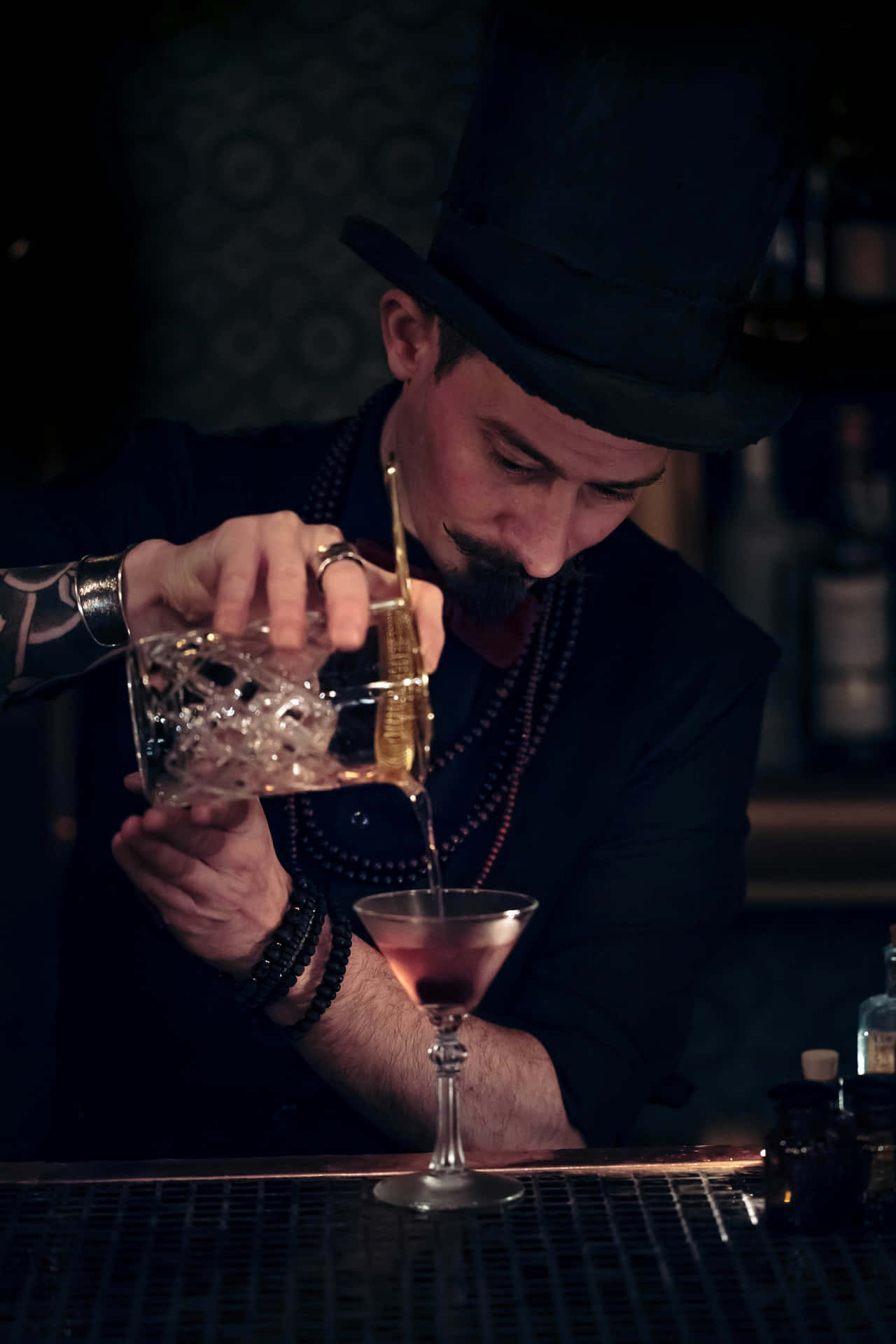 Bartender Pouring Cocktailin Dim Bar Wallpaper