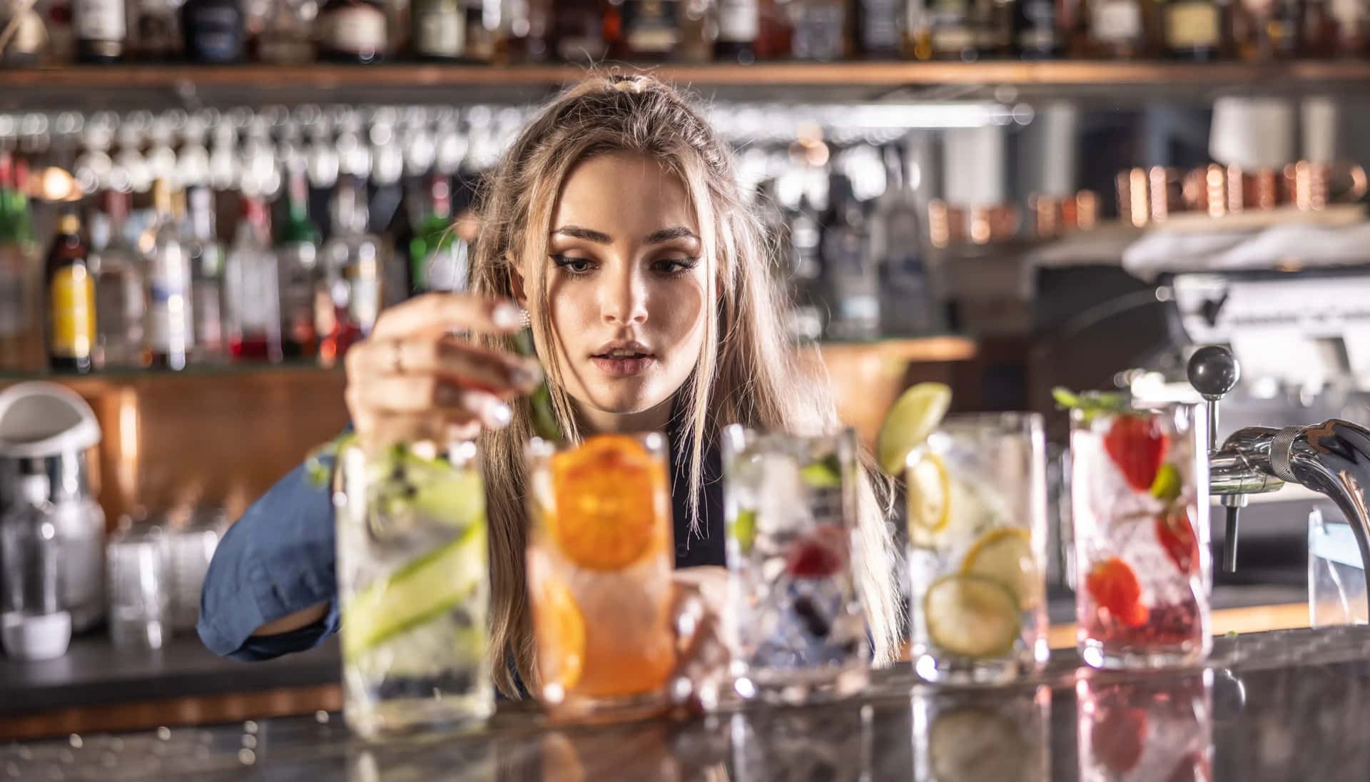 Download Bartender Preparing Fruit Cocktails Wallpaper | Wallpapers.com