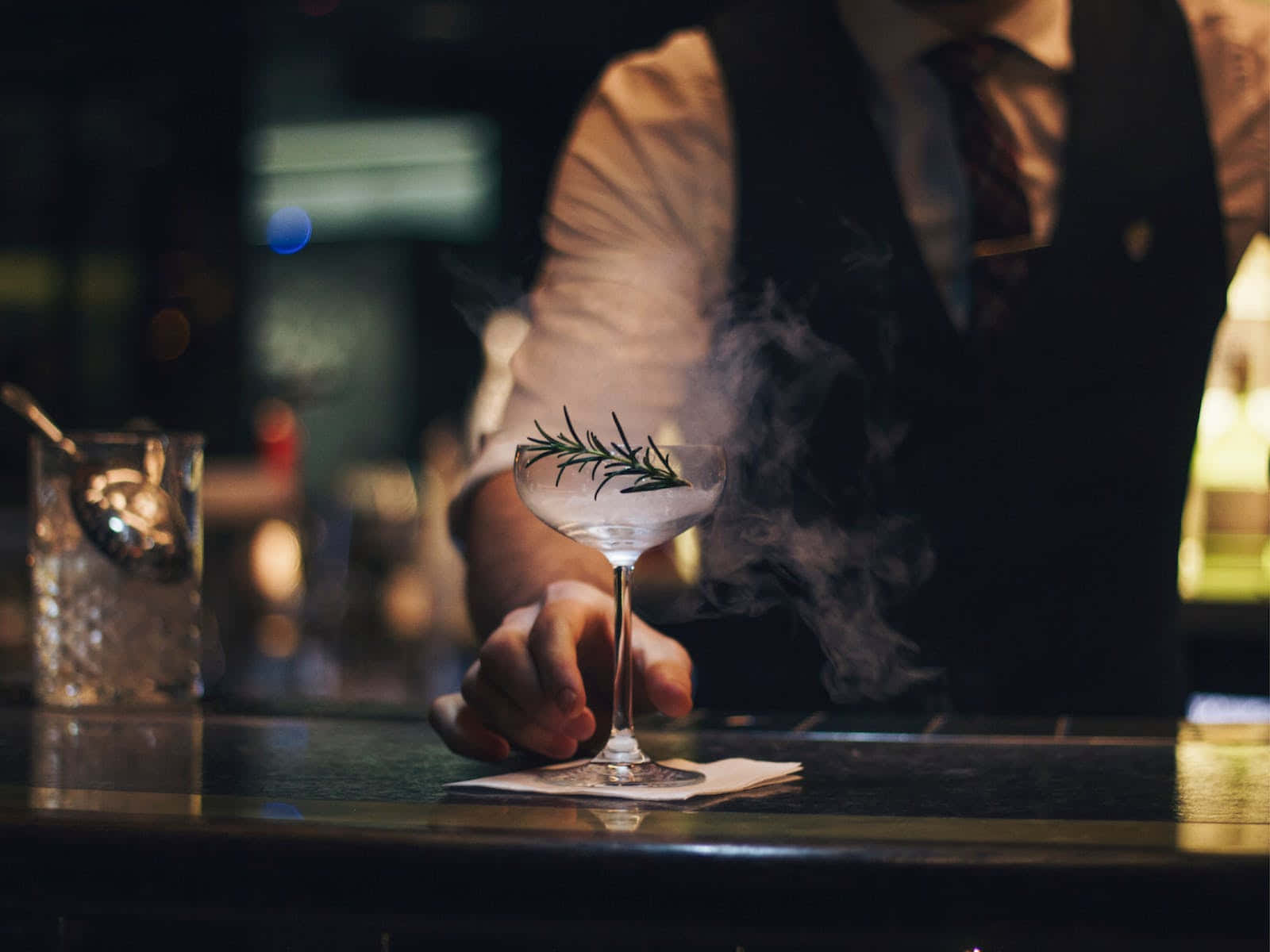 Download Bartender Serving Smoky Cocktail Wallpaper | Wallpapers.com