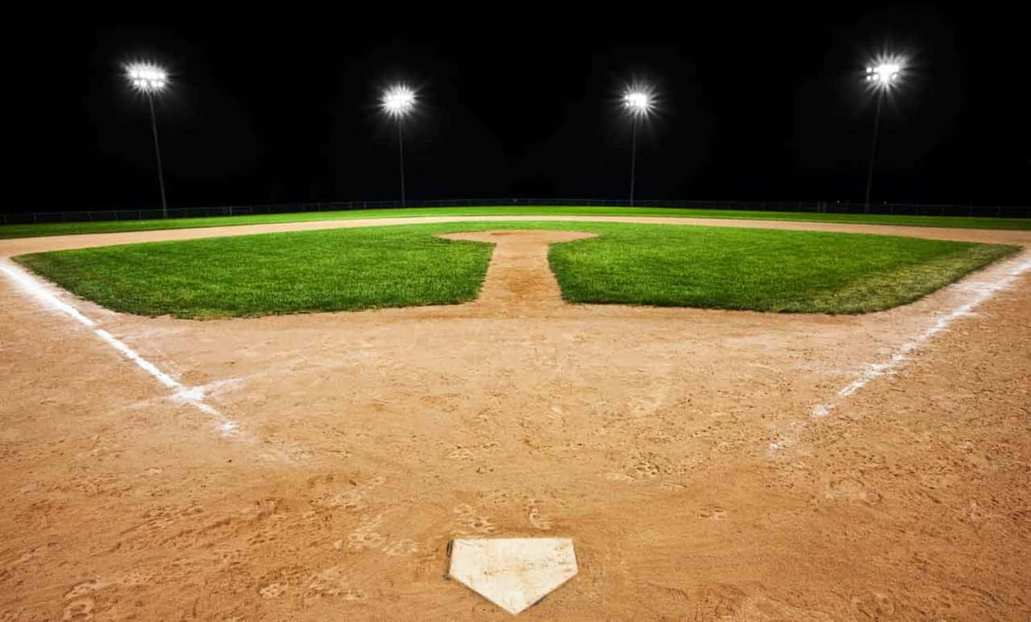 A Baseball Field At Night With Lights