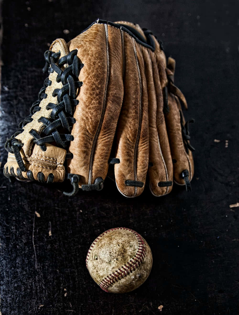 Close-up image of three leather baseball gloves Wallpaper