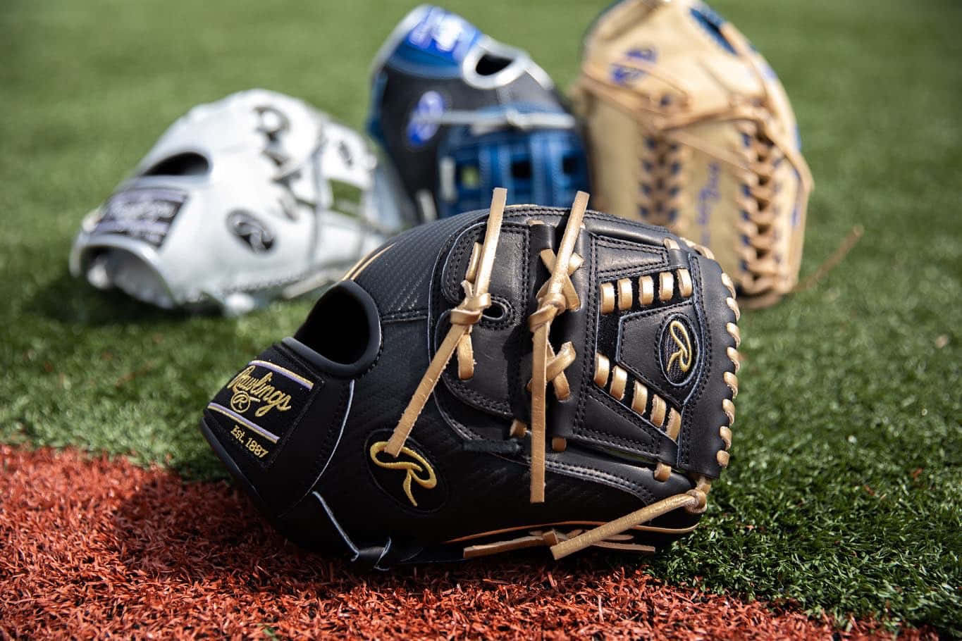 Baseball gloves on a playing field Wallpaper