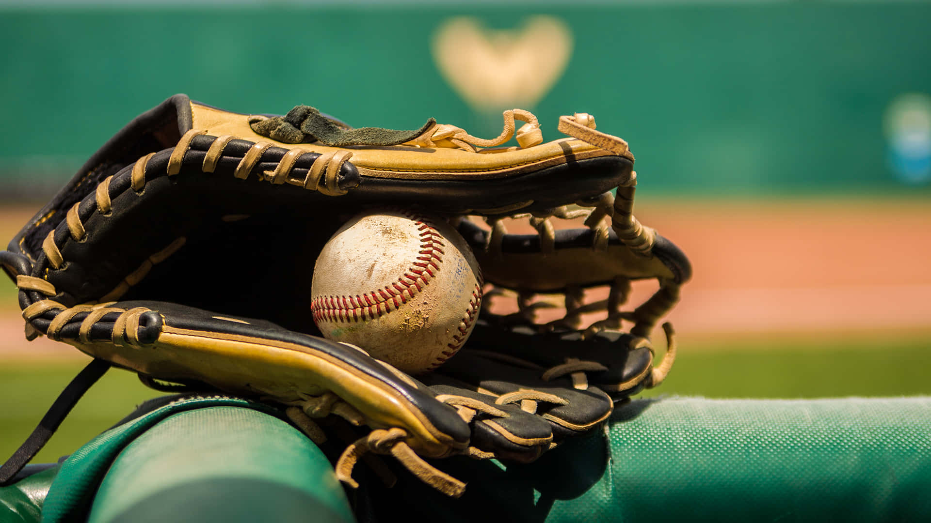 A close-up of a baseball glove on the field Wallpaper