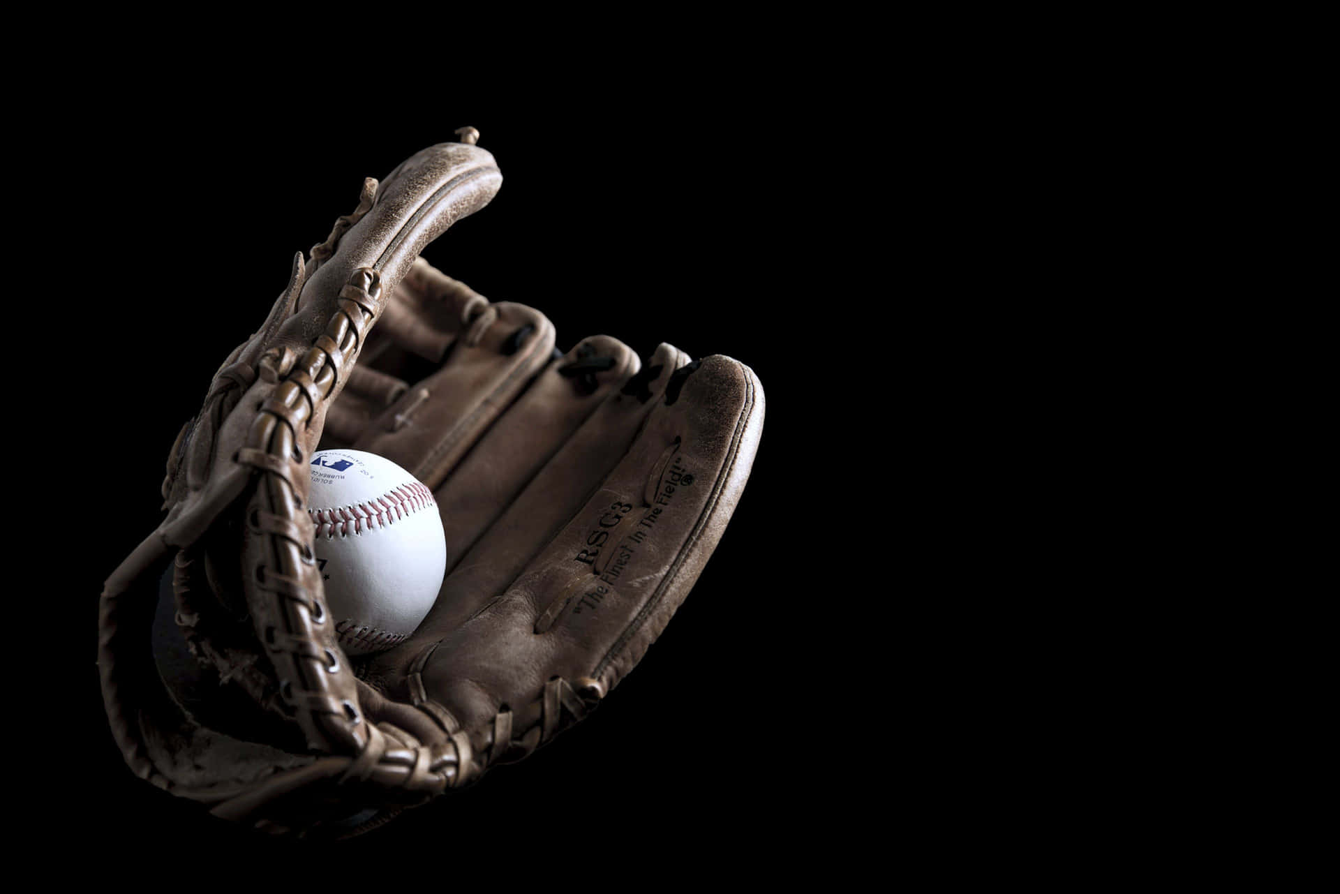 A Close-Up Look of a Baseball Glove Collection Wallpaper